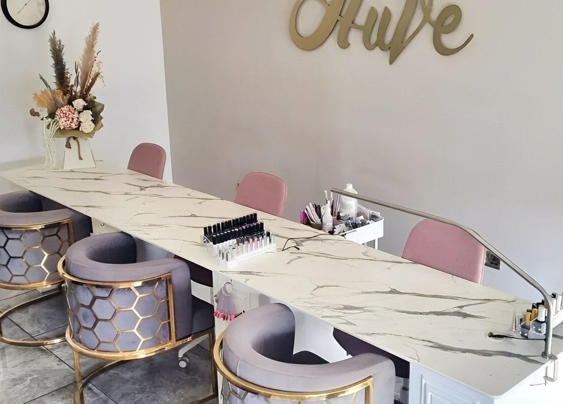 Elegant nail station at Hiive Expert Nails in Swinton, England, GB, featuring plush seating and modern decor.