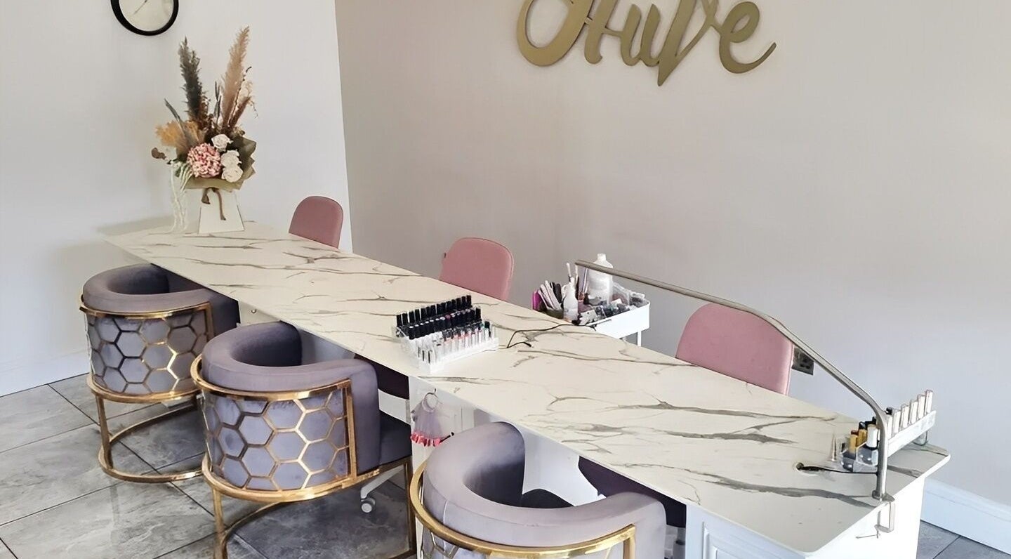 Elegant nail station at Hiive Expert Nails in Swinton, England, GB, featuring plush seating and modern decor.