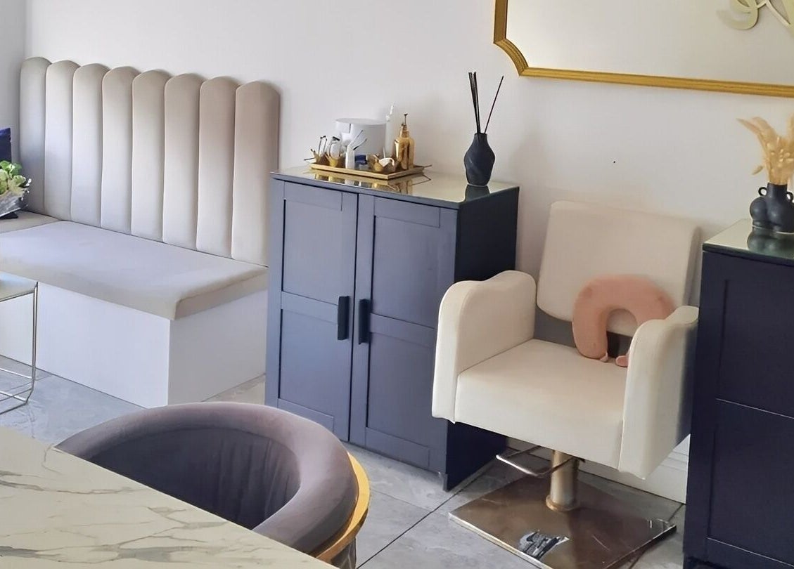 Elegant waiting area at Hiive Expert Nails, Swinton, England, with plush seating and modern decor.