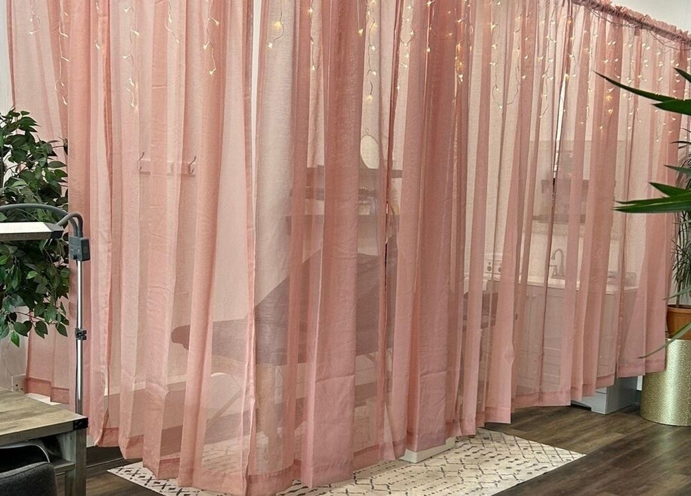 Elegant pink curtains in Modern Esthetics, Carstairs, Alberta, CA, creating a serene spa atmosphere.
