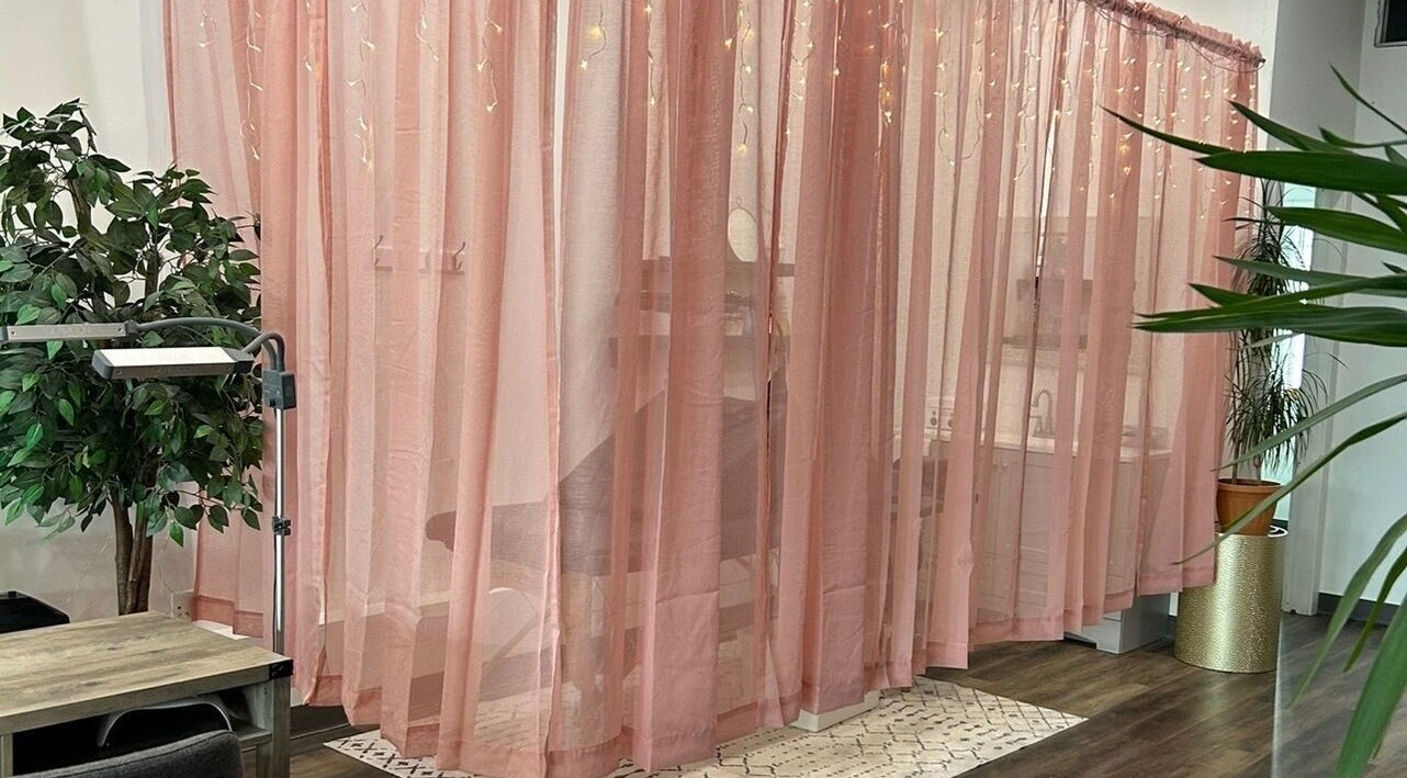 Elegant pink curtains in Modern Esthetics, Carstairs, Alberta, CA, creating a serene spa atmosphere.