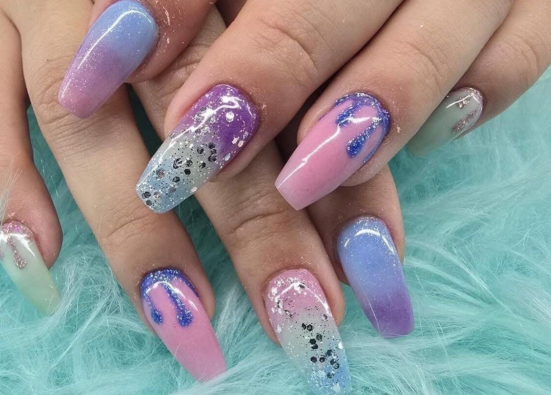 Elegant nail art with pink and purple hues at Modern Esthetics, Carstairs, Alberta, CA.