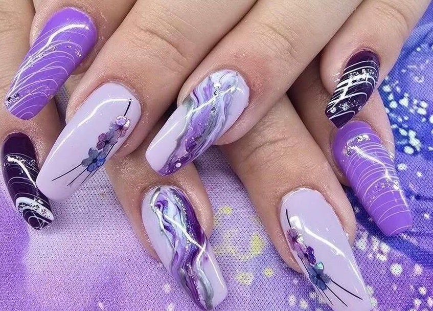 Elegant purple nail art at Modern Esthetics in Carstairs, Alberta, CA. Exquisite manicure design.