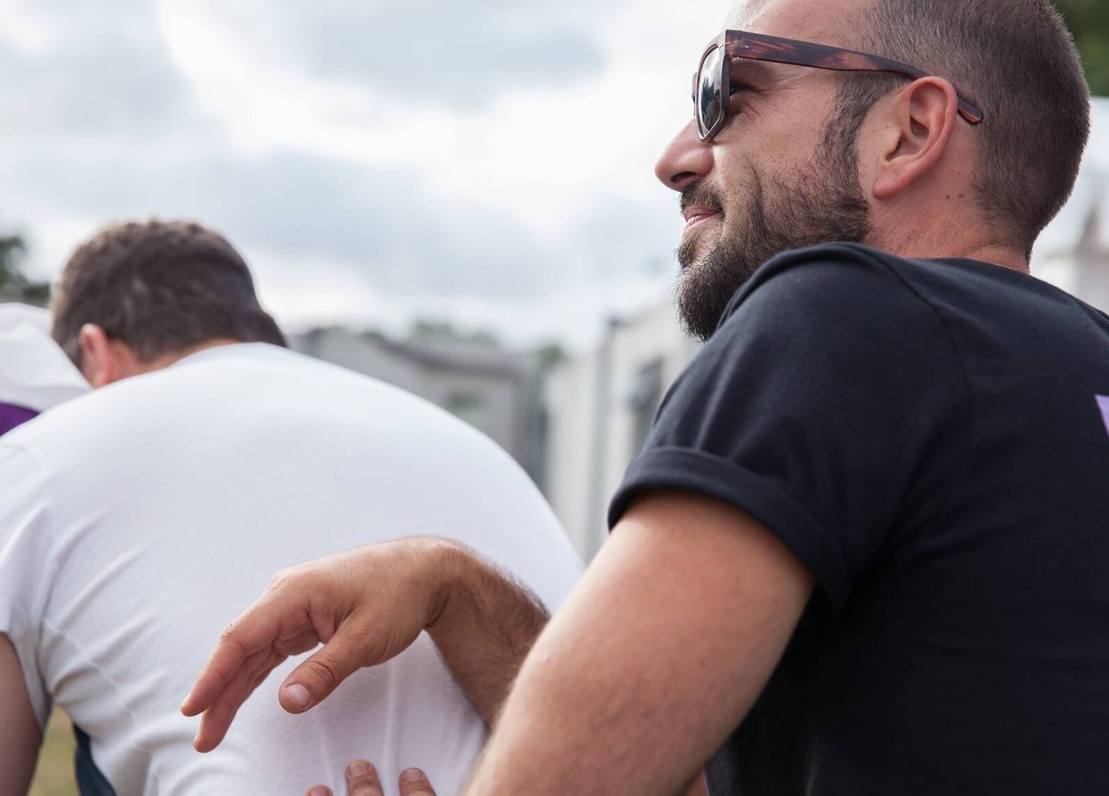 Massage therapist at Latitude Luxury in Southwold, England, GB, providing a relaxing outdoor back massage.