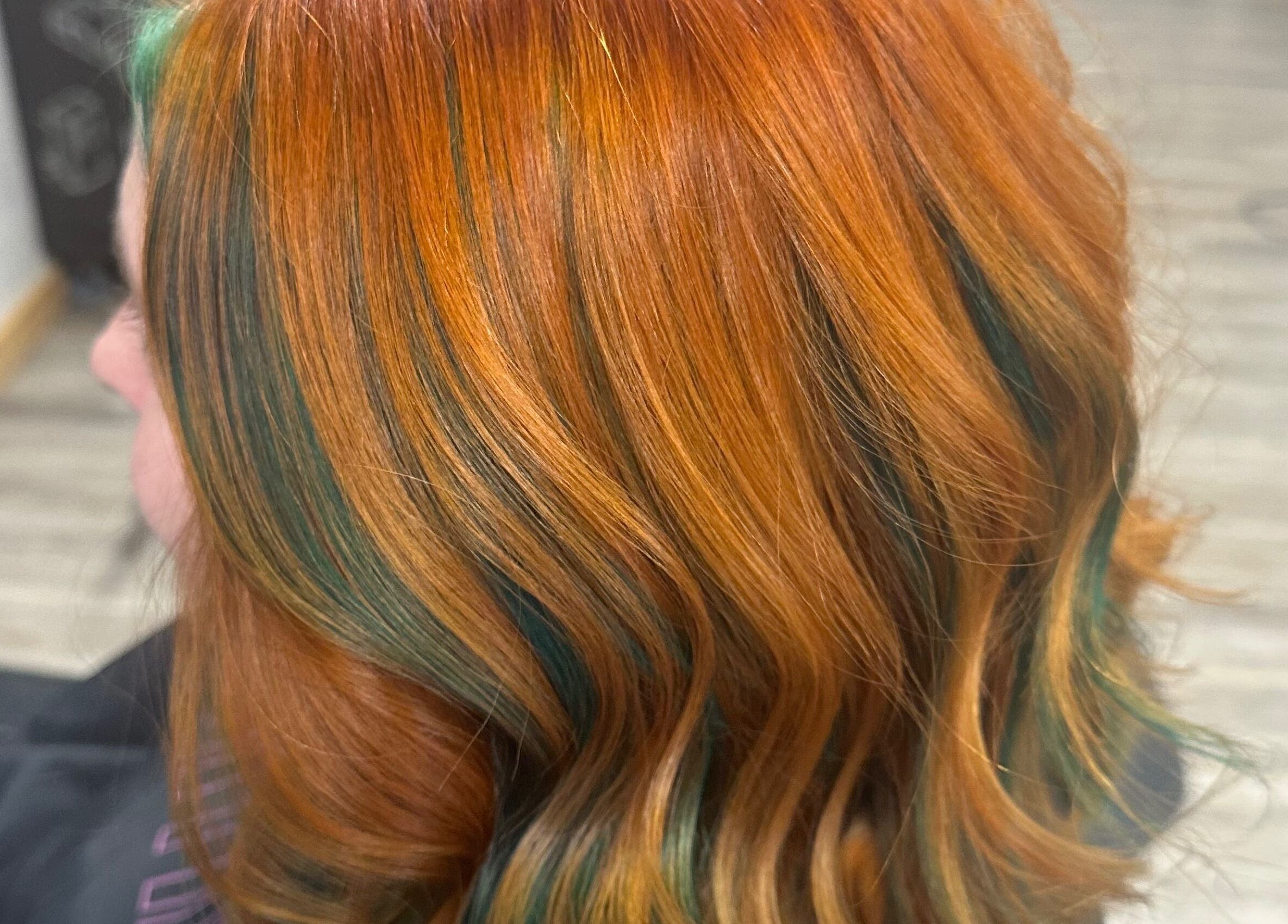 Vibrant orange and teal hair highlights at Sparkling Style - Meraki in Olds, Alberta, CA.