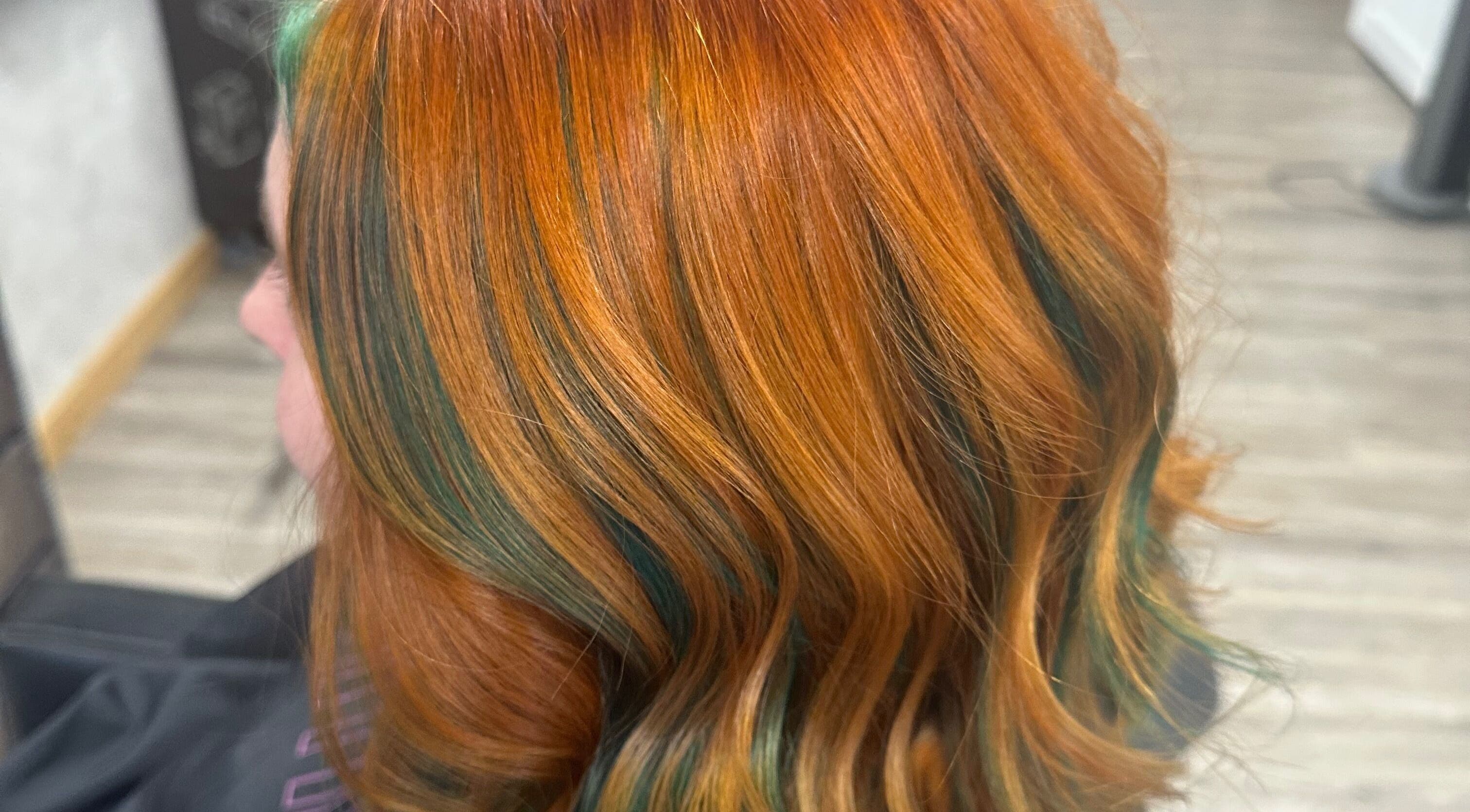 Vibrant orange and teal hair highlights at Sparkling Style - Meraki in Olds, Alberta, CA.