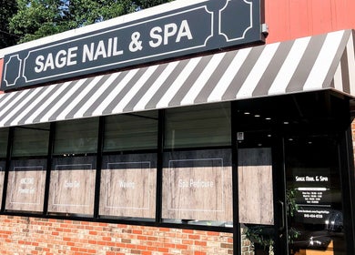 Exterior of Sage Nail & Spa in Poughkeepsie, New York with brick facade and striped awning.
