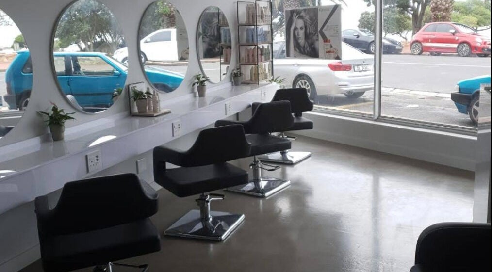 Sleek salon interior at Mirror Number 9, Cape Town with modern decor and styling chairs.