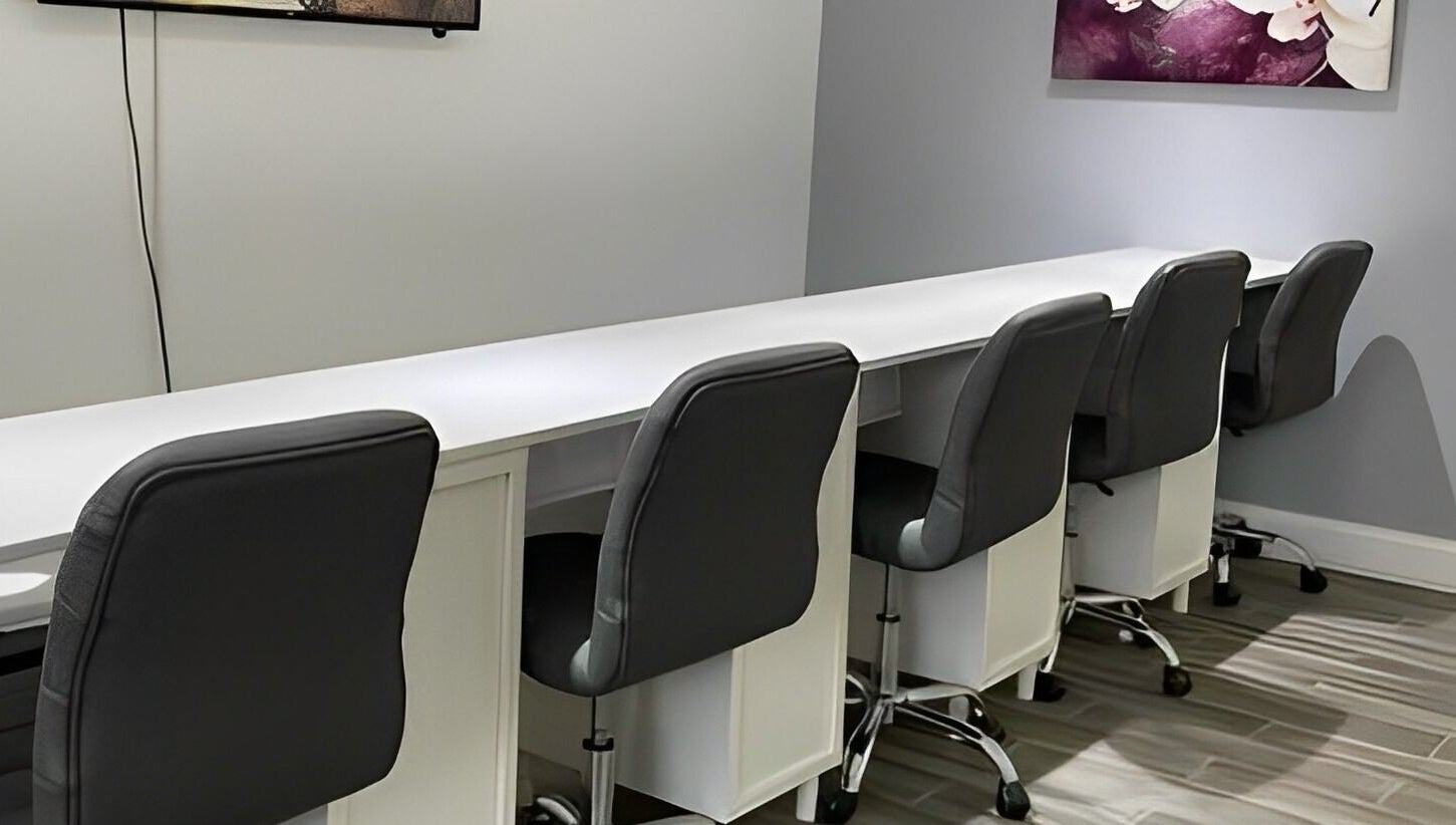 Modern nail bar setup at Sofia Nails & Spa in Newton, Massachusetts, US, featuring sleek chairs and workstations.