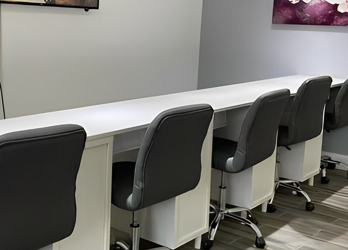 Modern nail bar setup at Sofia Nails & Spa in Newton, Massachusetts, US, featuring sleek chairs and workstations.