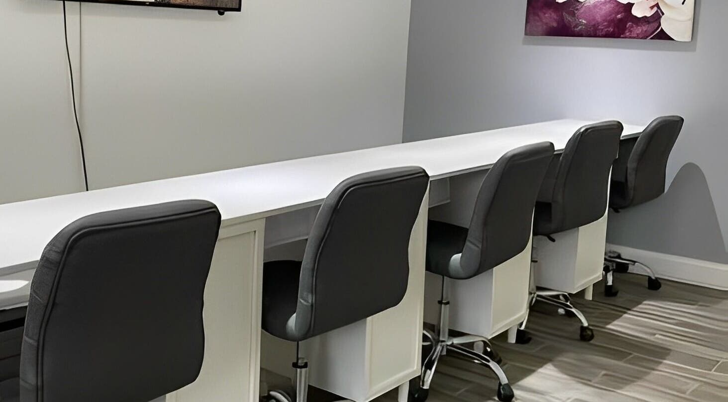 Modern nail bar setup at Sofia Nails & Spa in Newton, Massachusetts, US, featuring sleek chairs and workstations.