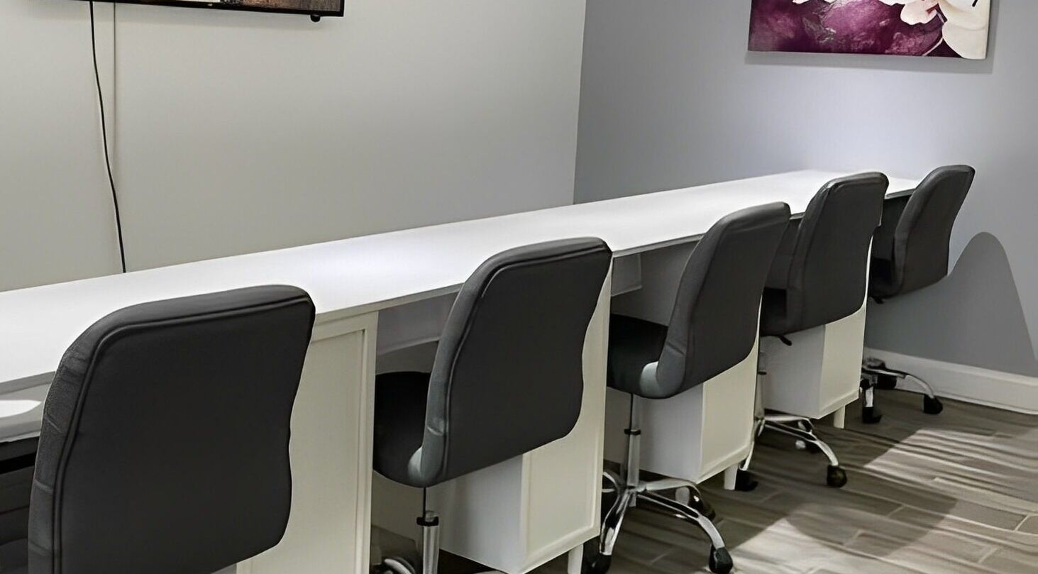 Modern nail bar setup at Sofia Nails & Spa in Newton, Massachusetts, US, featuring sleek chairs and workstations.