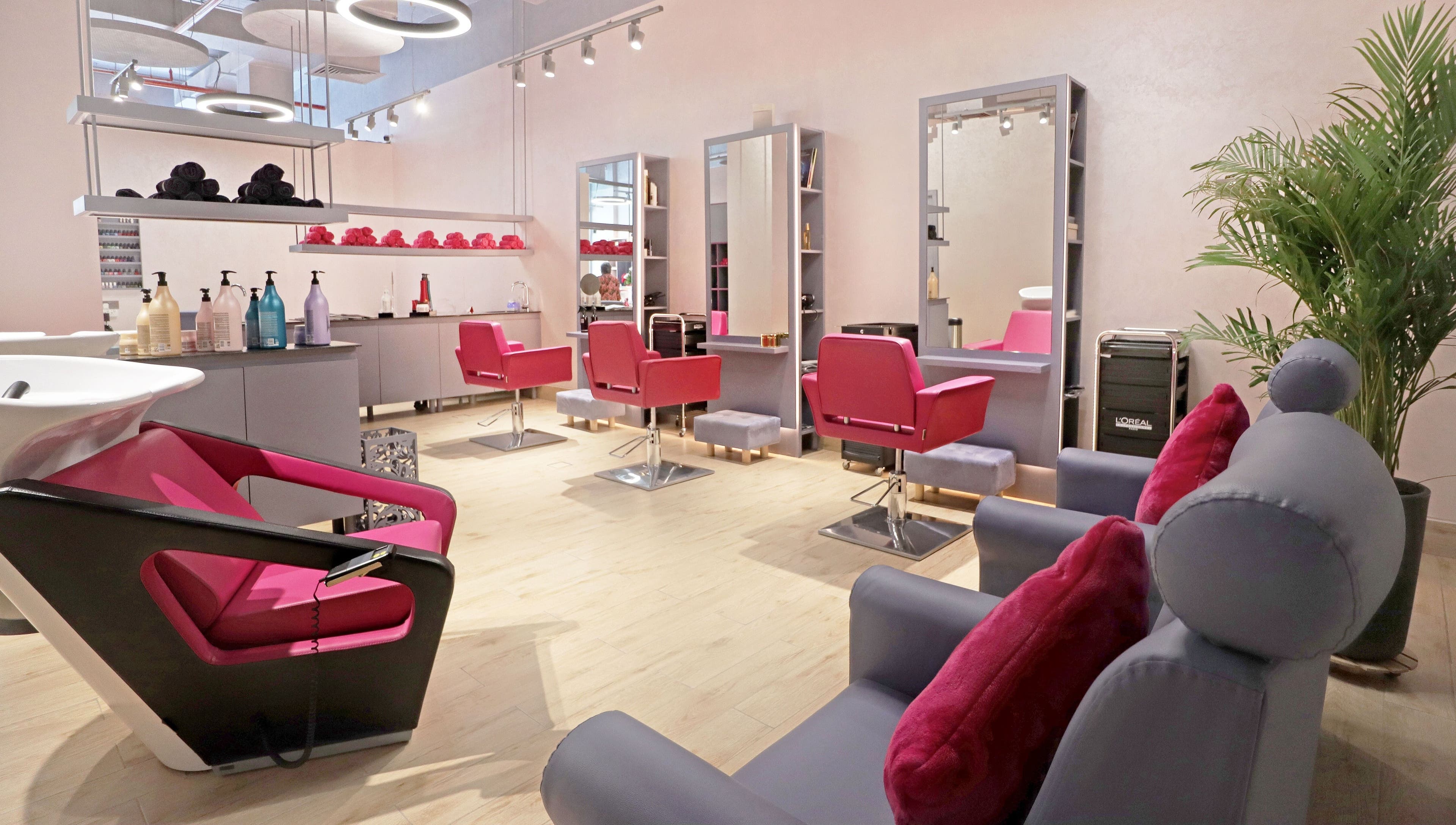 Modern beauty salon interior with red chairs at Mastercuts UAE, Dubai, Dubai, AE, offering premium wellness services.
