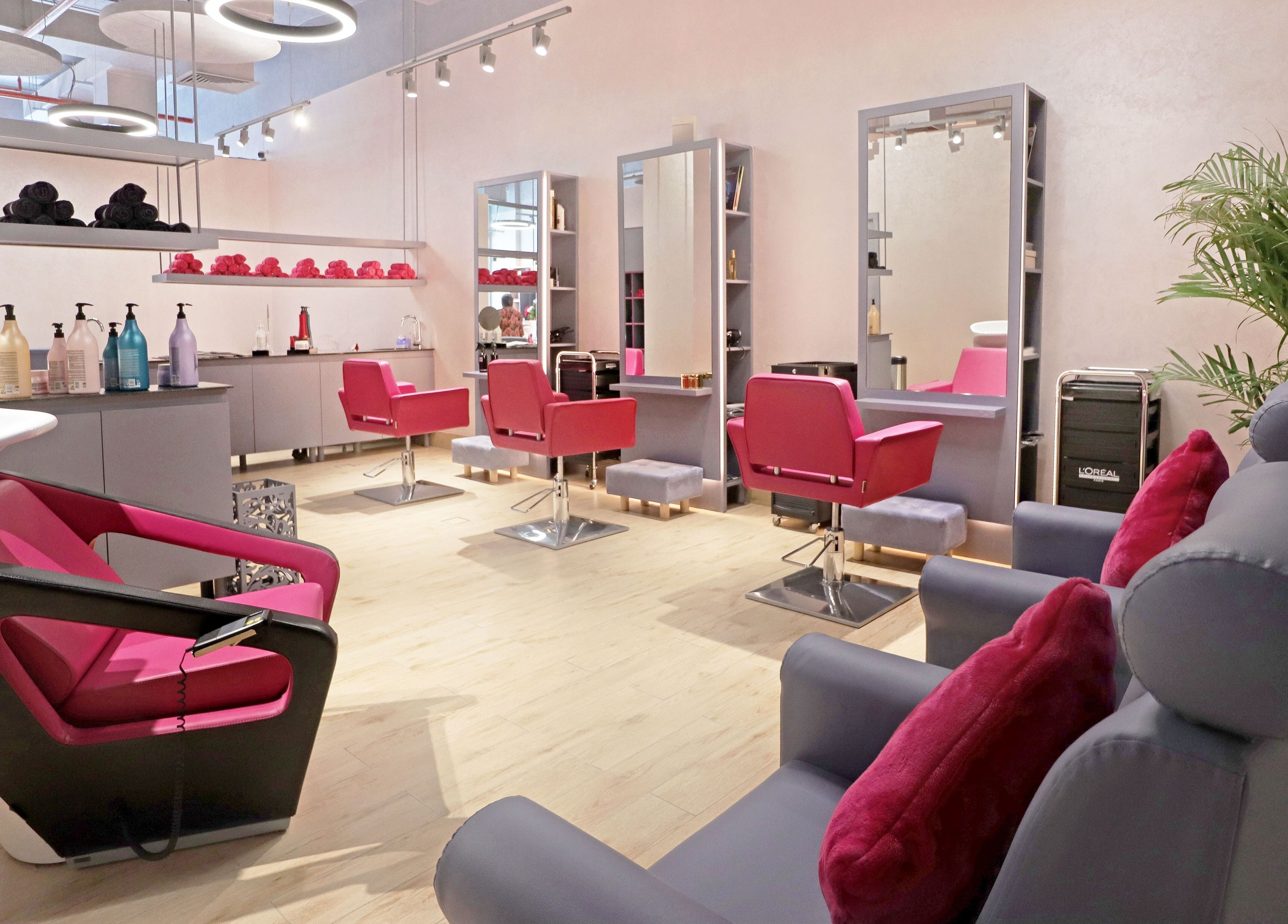 Modern beauty salon interior with red chairs at Mastercuts UAE, Dubai, Dubai, AE, offering premium wellness services.