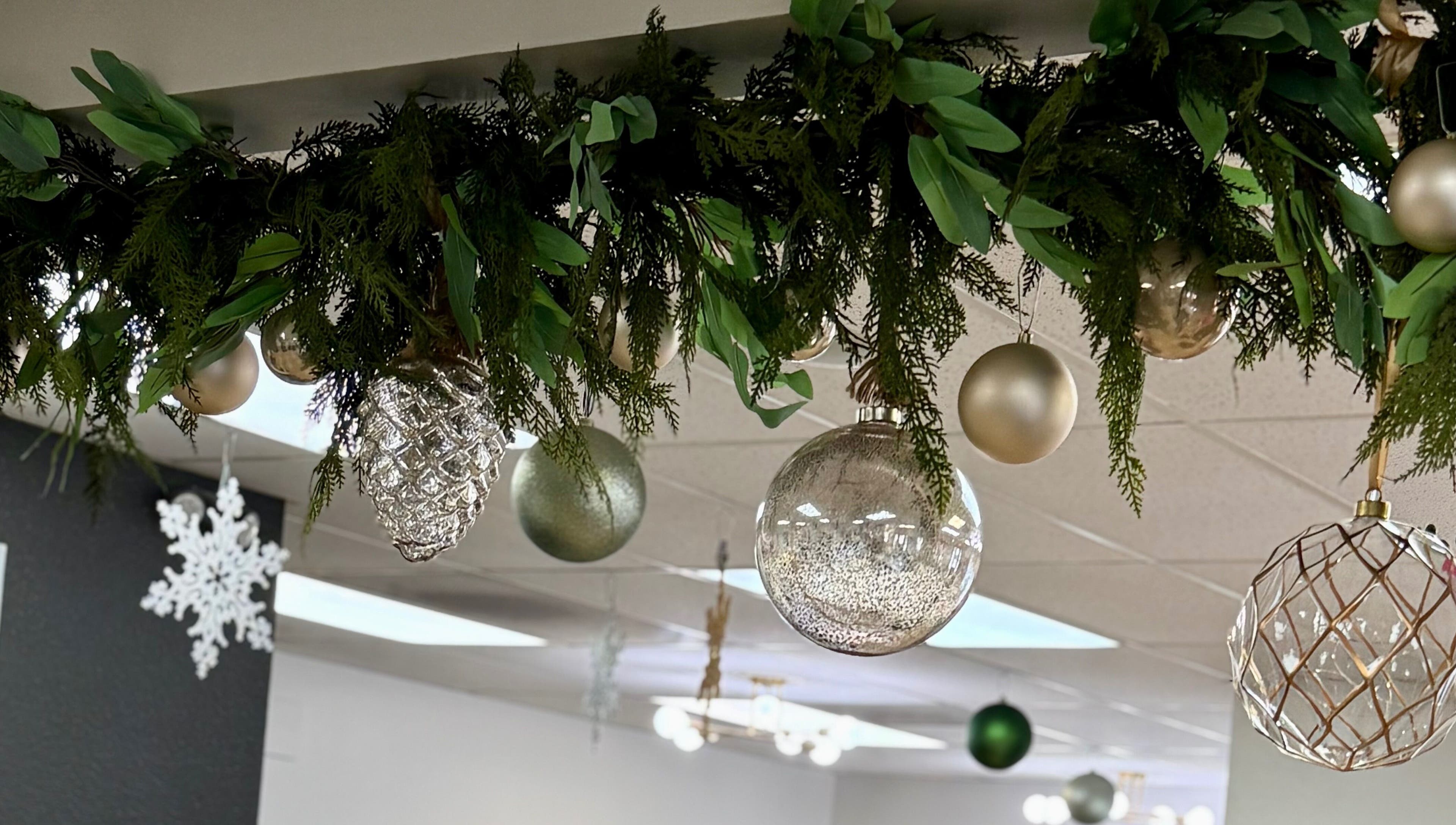 Chic holiday decor at Katie @ Salon Nuvo in Lee's Summit, Missouri, US, featuring lush greenery and shimmering ornaments.