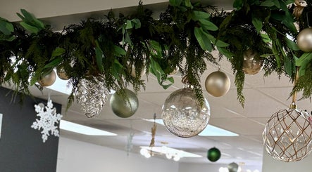 Chic holiday decor at Katie @ Salon Nuvo in Lee's Summit, Missouri, US, featuring lush greenery and shimmering ornaments.