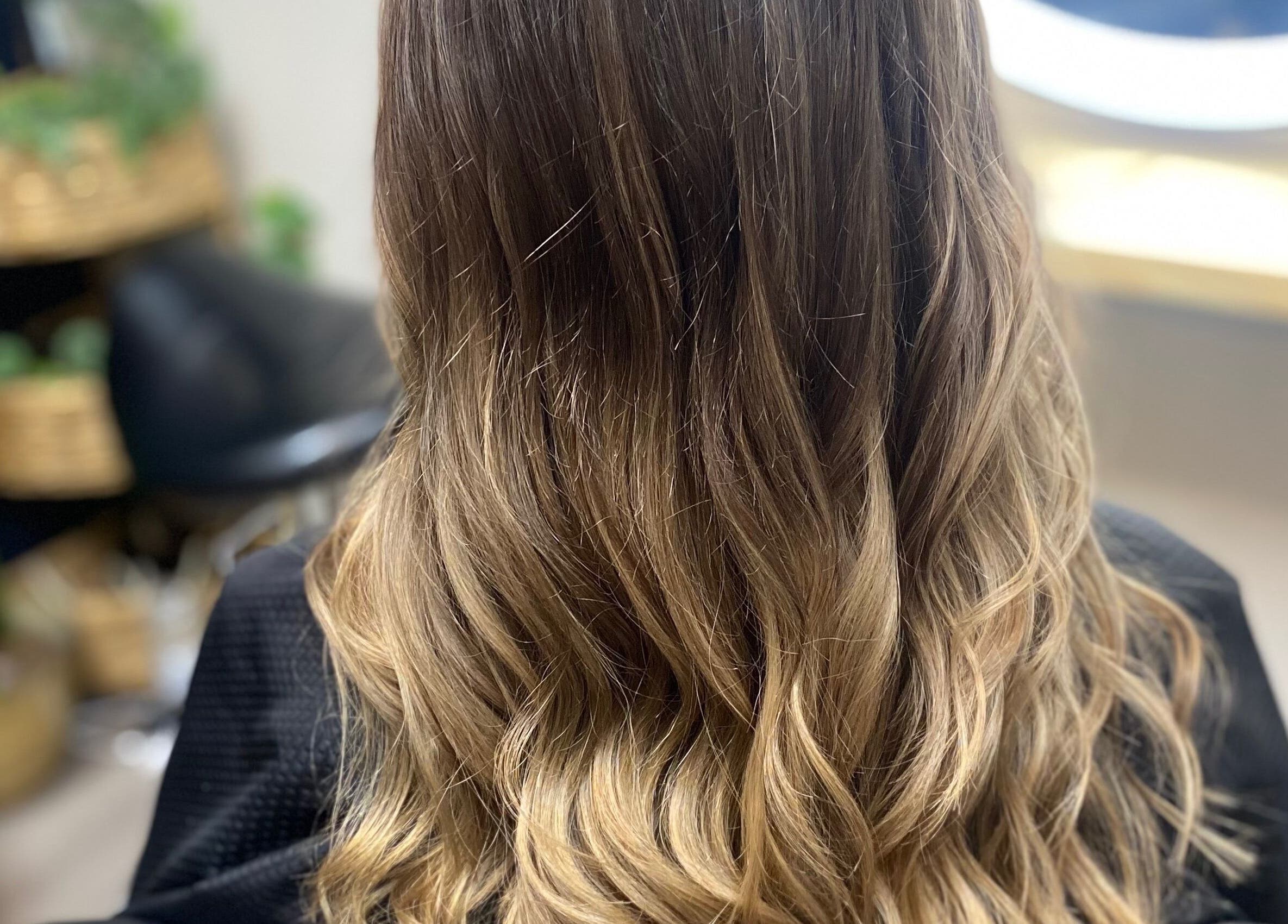 Glossy brown hair styled in waves at Katie @ Salon Nuvo, Lee's Summit, Missouri, US.