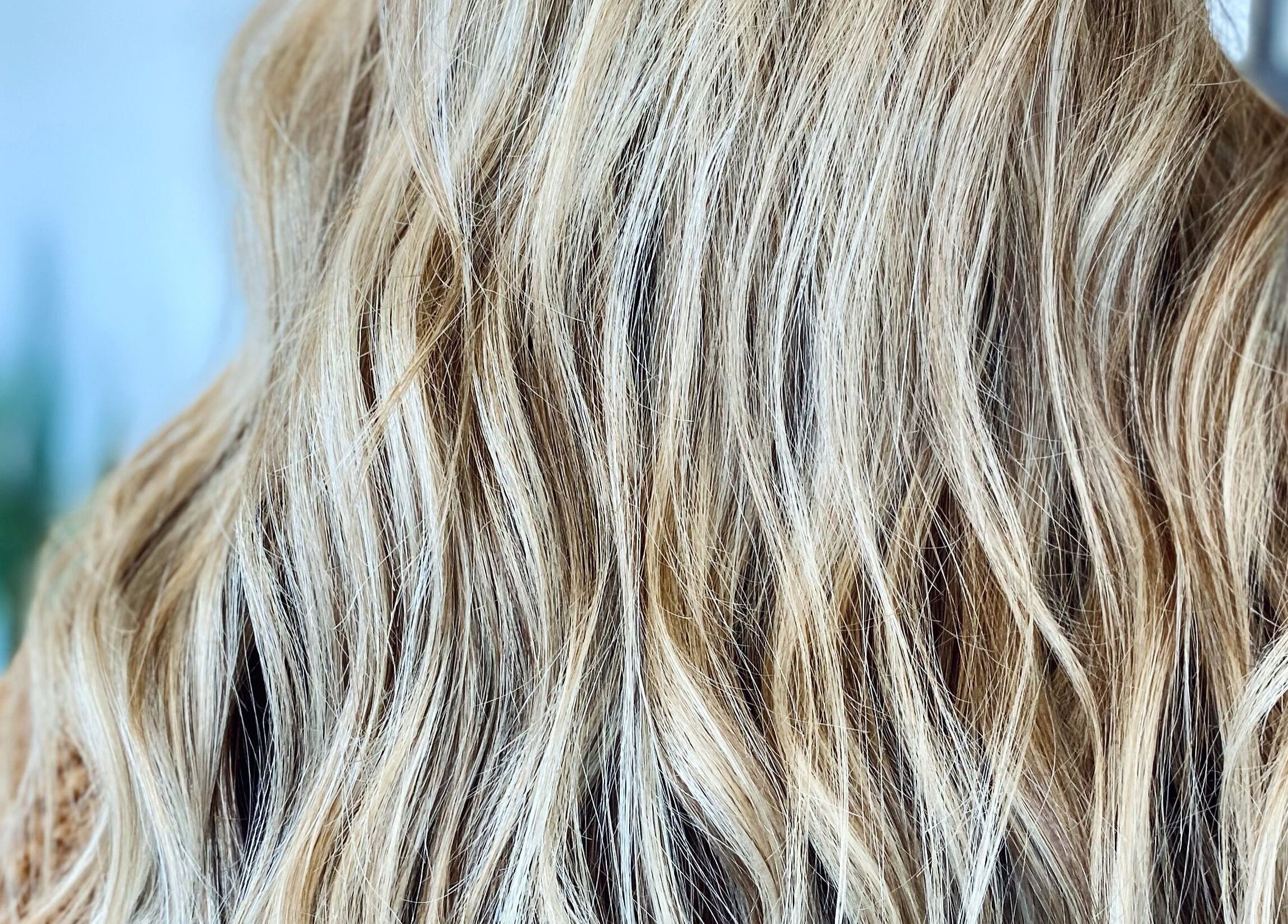 Close-up of golden wavy hair styled by Katie at Salon Nuvo, Lee's Summit, Missouri, US.