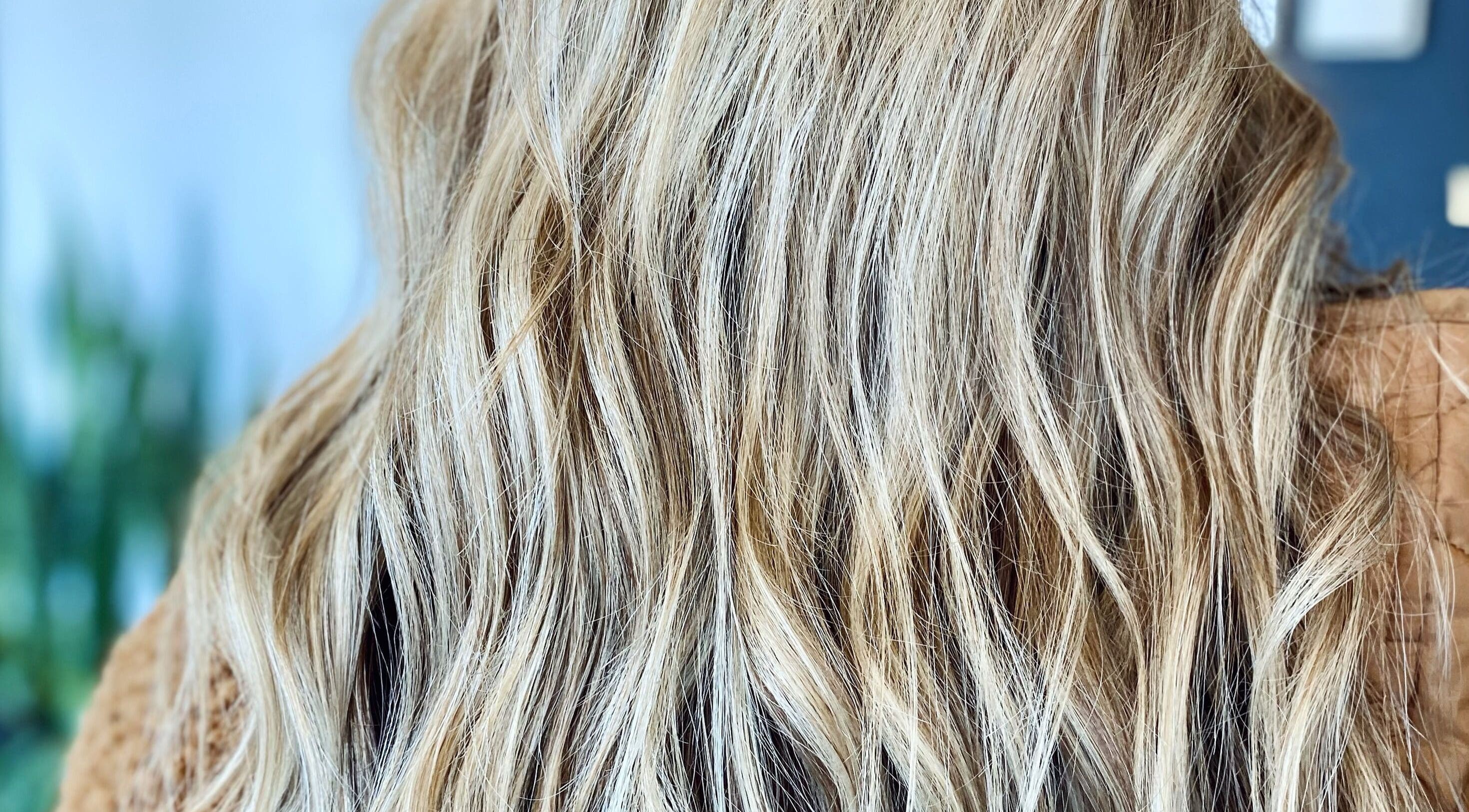 Close-up of golden wavy hair styled by Katie at Salon Nuvo, Lee's Summit, Missouri, US.