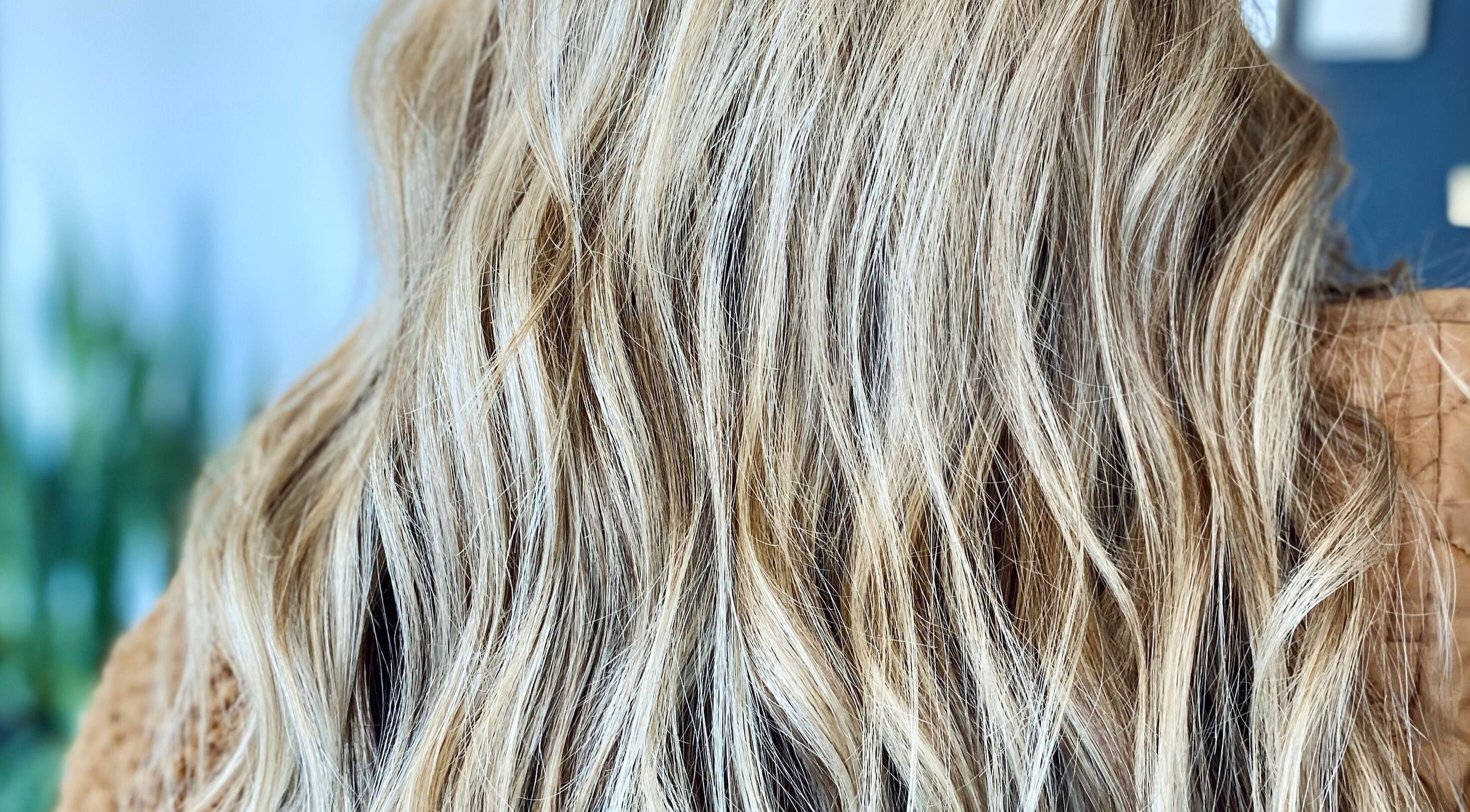 Close-up of golden wavy hair styled by Katie at Salon Nuvo, Lee's Summit, Missouri, US.