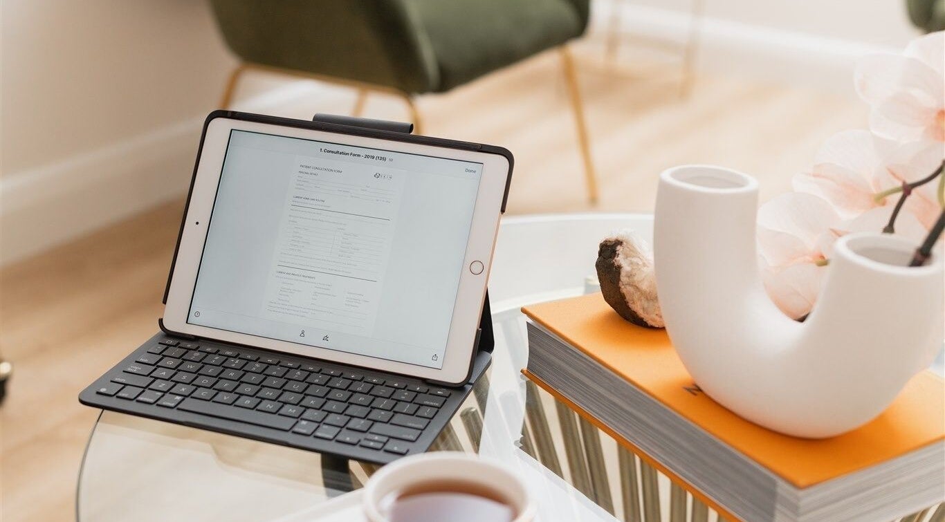 A tranquil workspace at The Glow Lab, Wagga Wagga, New South Wales, AU, featuring a tablet and elegant decor.