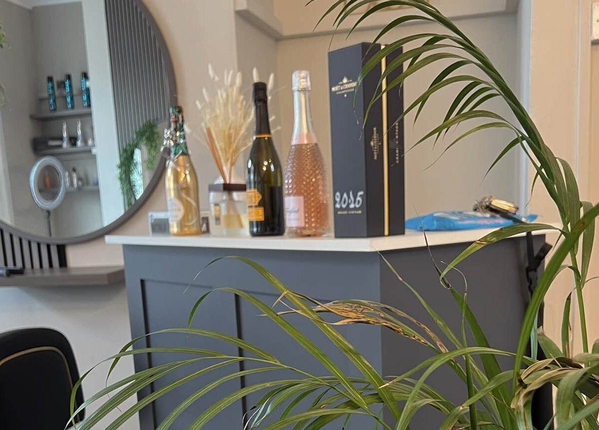 Stylish interior at Chelsea Geddes Hair, Peel, IM with mirrors and decor.