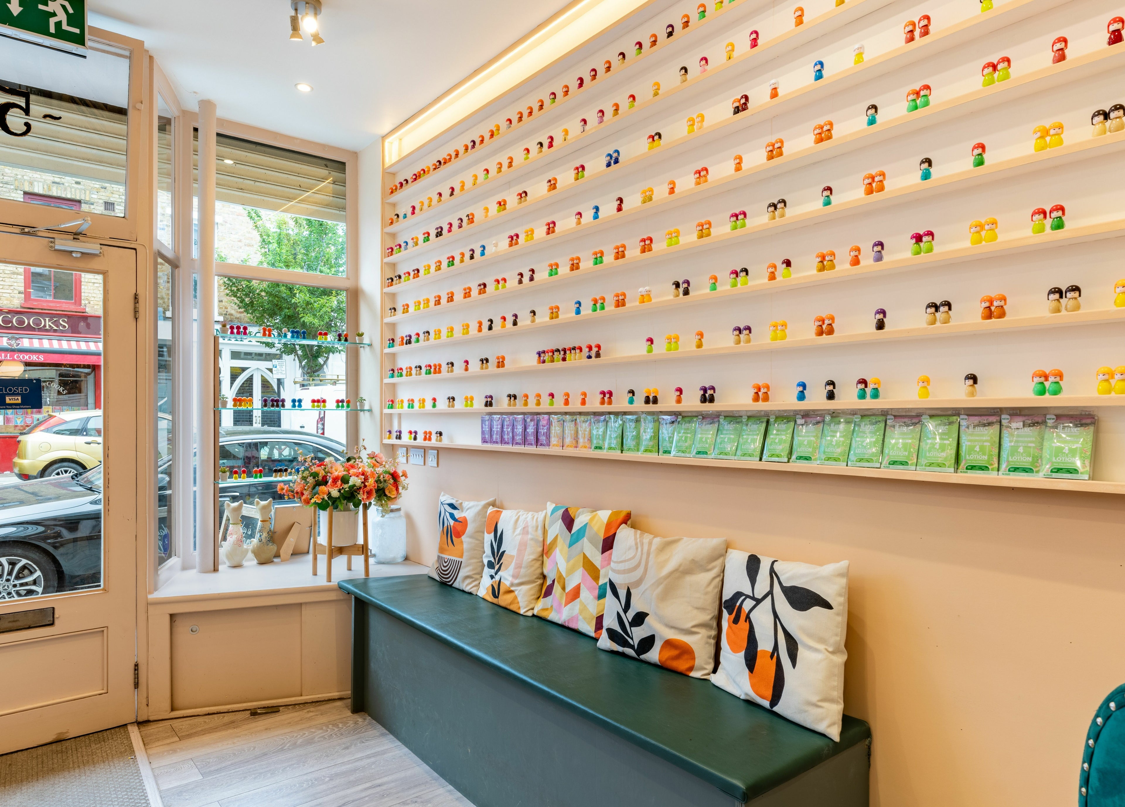 Inviting interior at Eighty-8 Notting Hill, London, England, GB with colorful wall display and cozy seating.