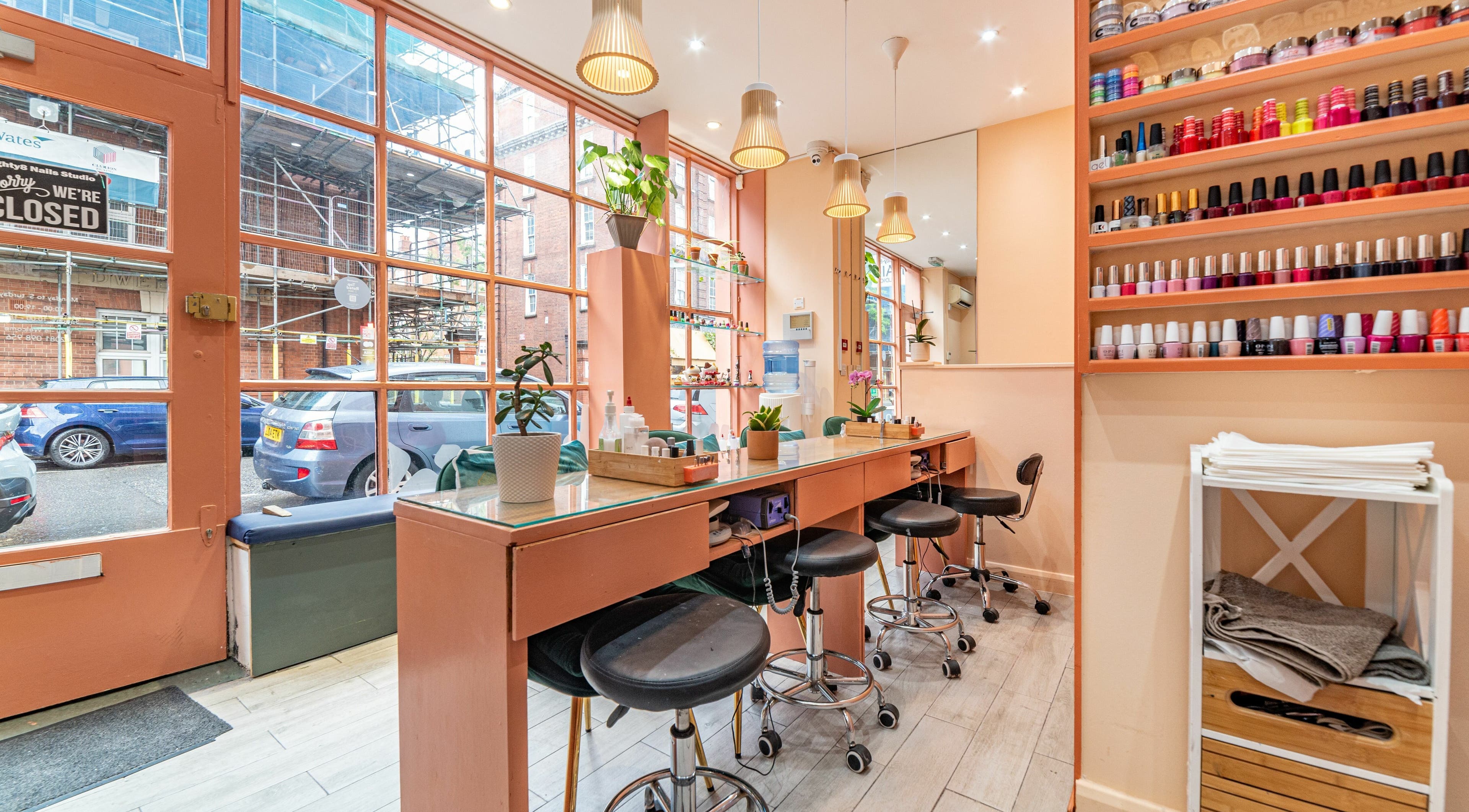 Interior of Eighty-8 Cale Street nail salon in London, England, GB featuring stylish design and polish display.