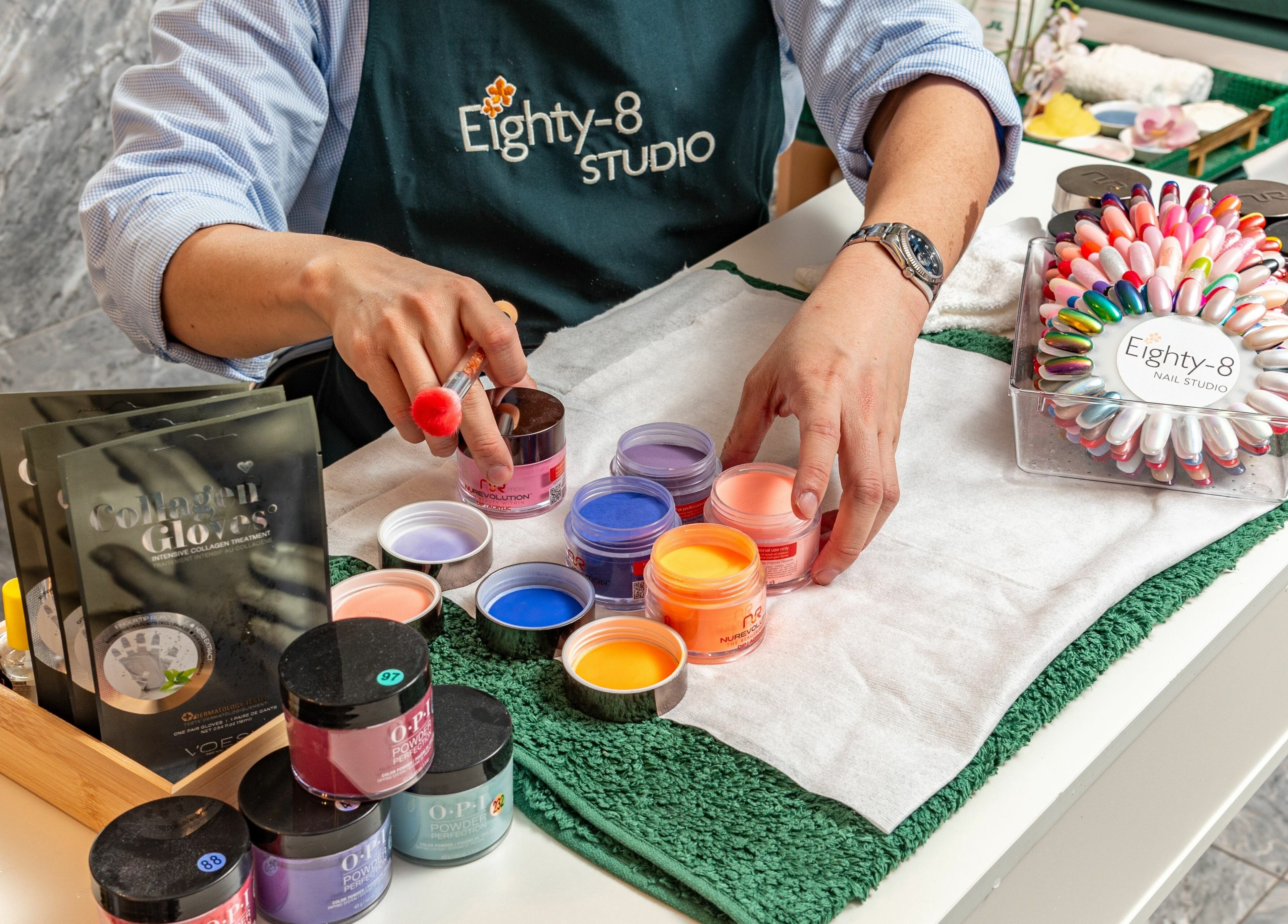 Nail art supplies at Eighty-8 Cale Street, London, England, GB. A technician arranges vibrant products.