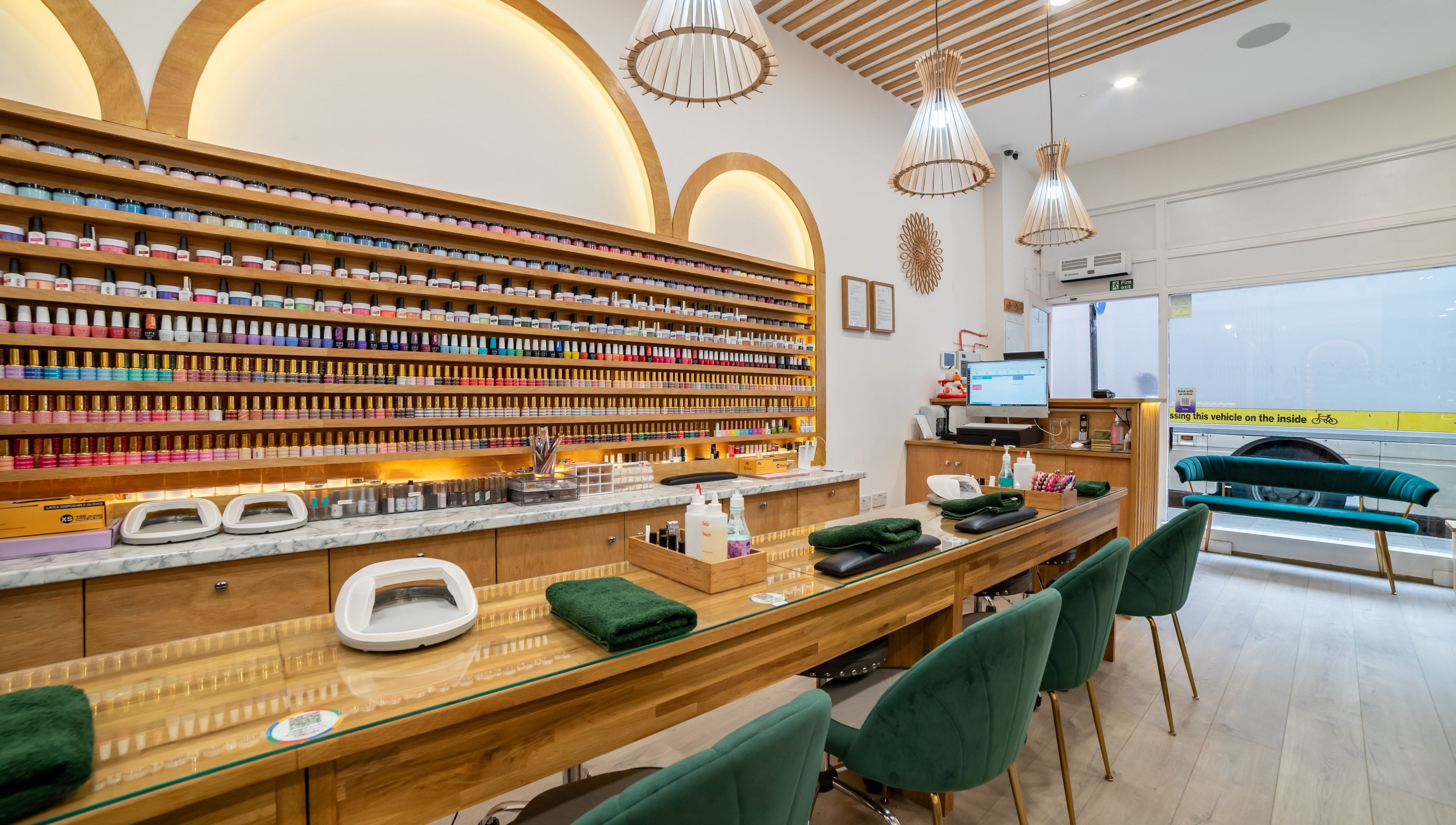Stylish nail bar interior at Eighty-8 Covent Garden, London, England, GB, featuring plush seating and color displays.