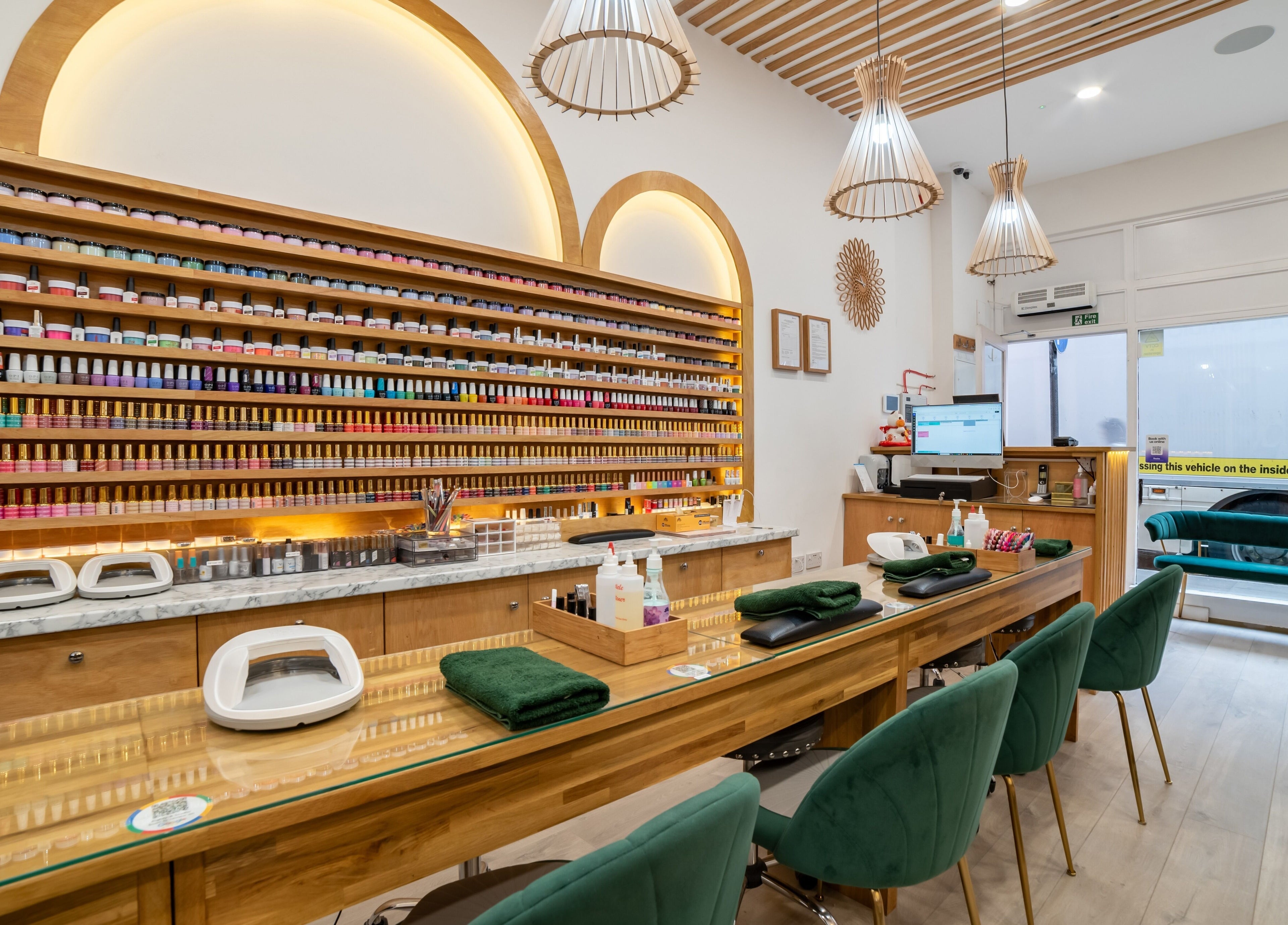 Stylish nail bar interior at Eighty-8 Covent Garden, London, England, GB, featuring plush seating and color displays.