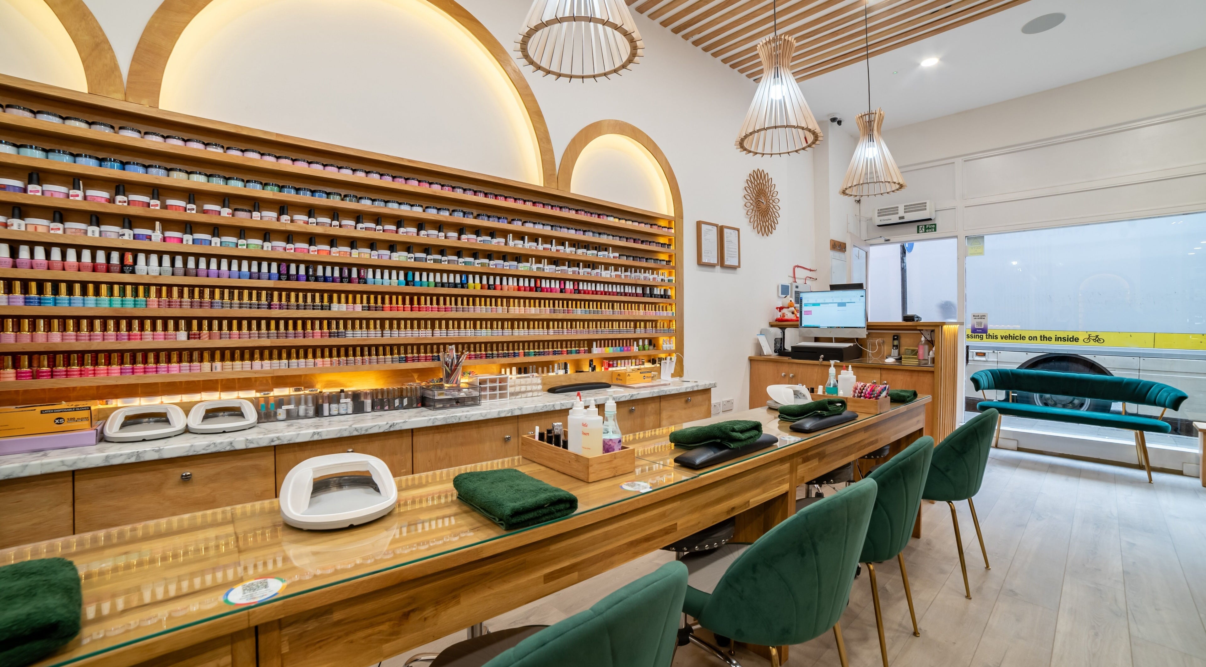 Stylish nail bar interior at Eighty-8 Covent Garden, London, England, GB, featuring plush seating and color displays.