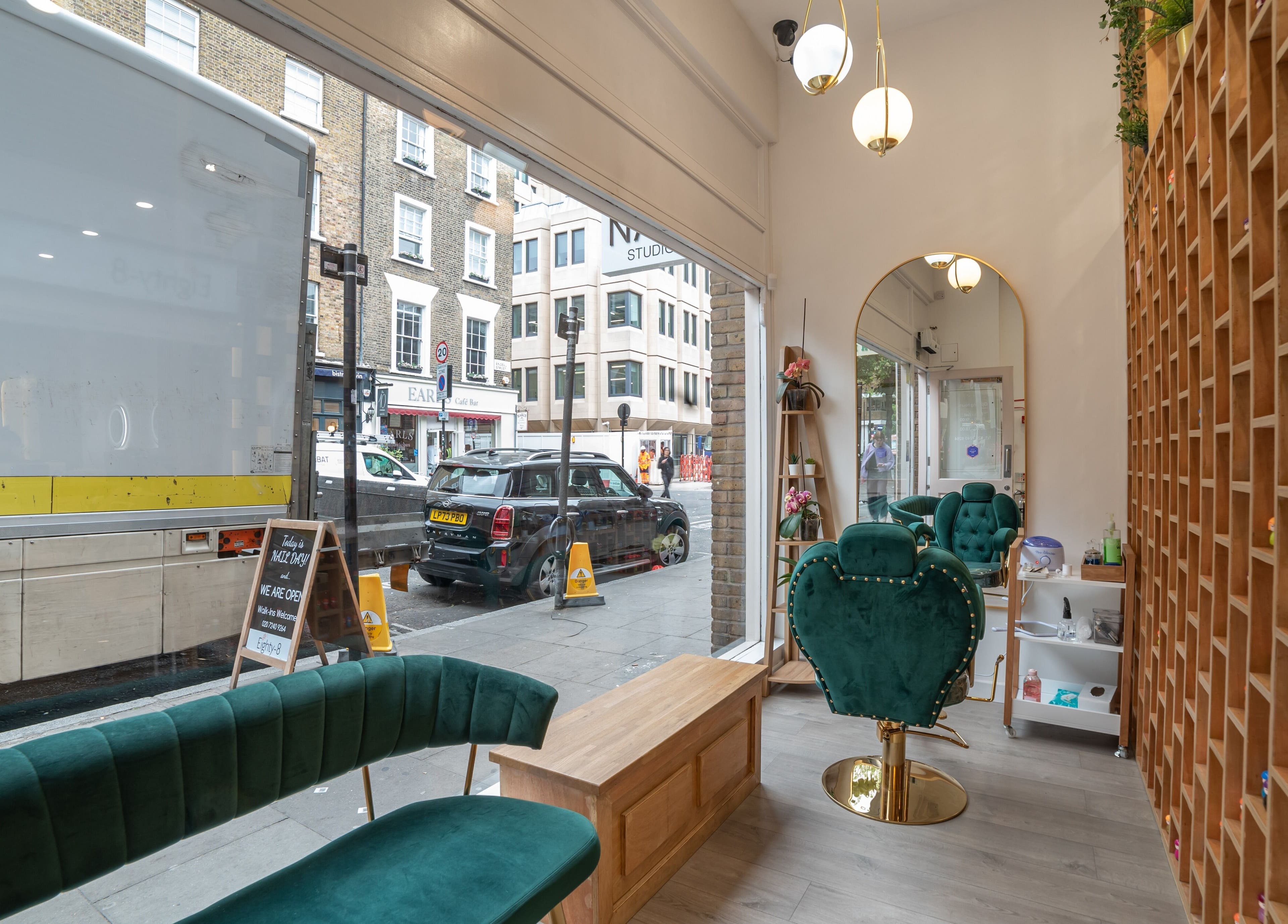 Interior view of Eighty-8 Covent Garden, London, England, GB showcasing cushioned seating and stylish decor.