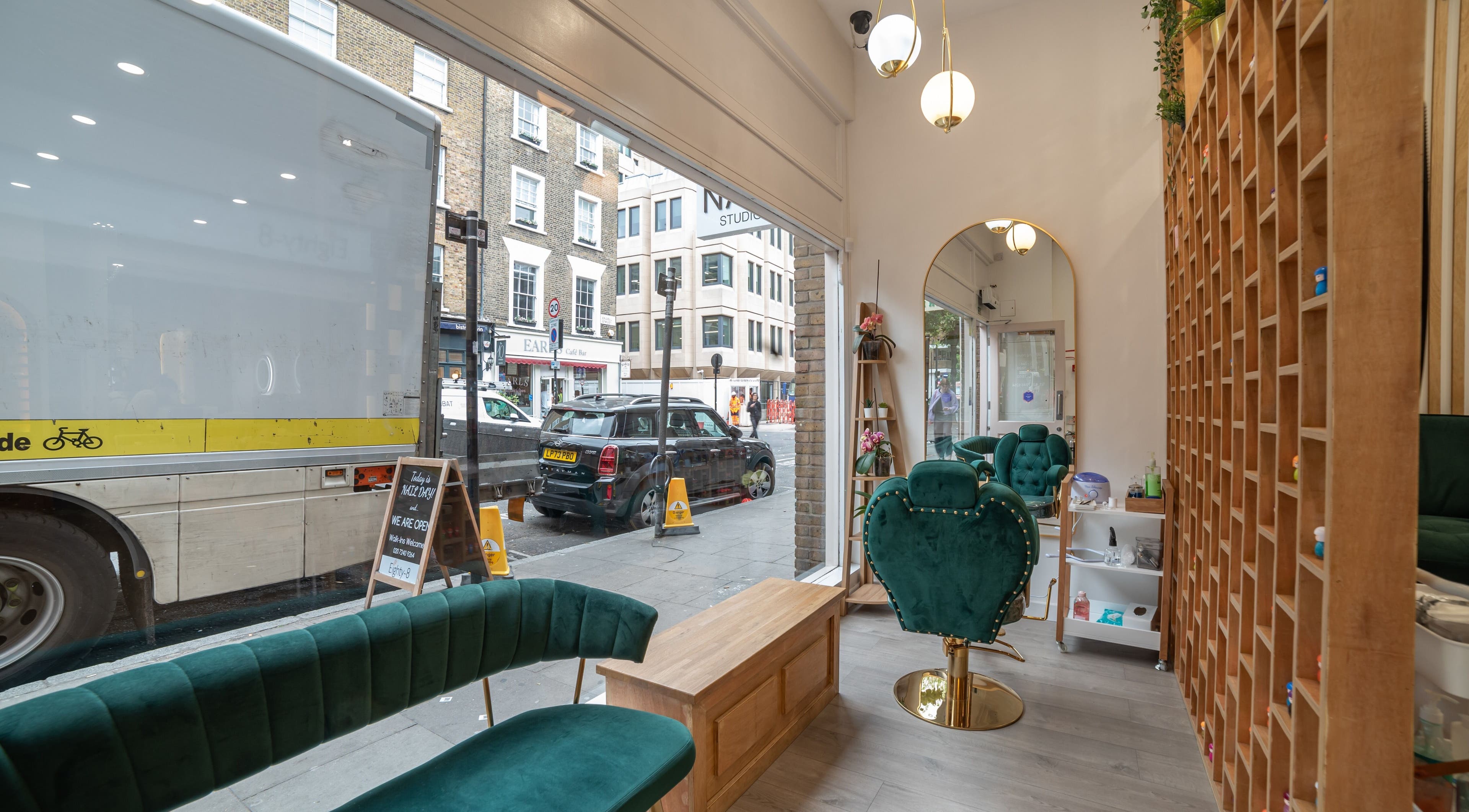 Interior view of Eighty-8 Covent Garden, London, England, GB showcasing cushioned seating and stylish decor.