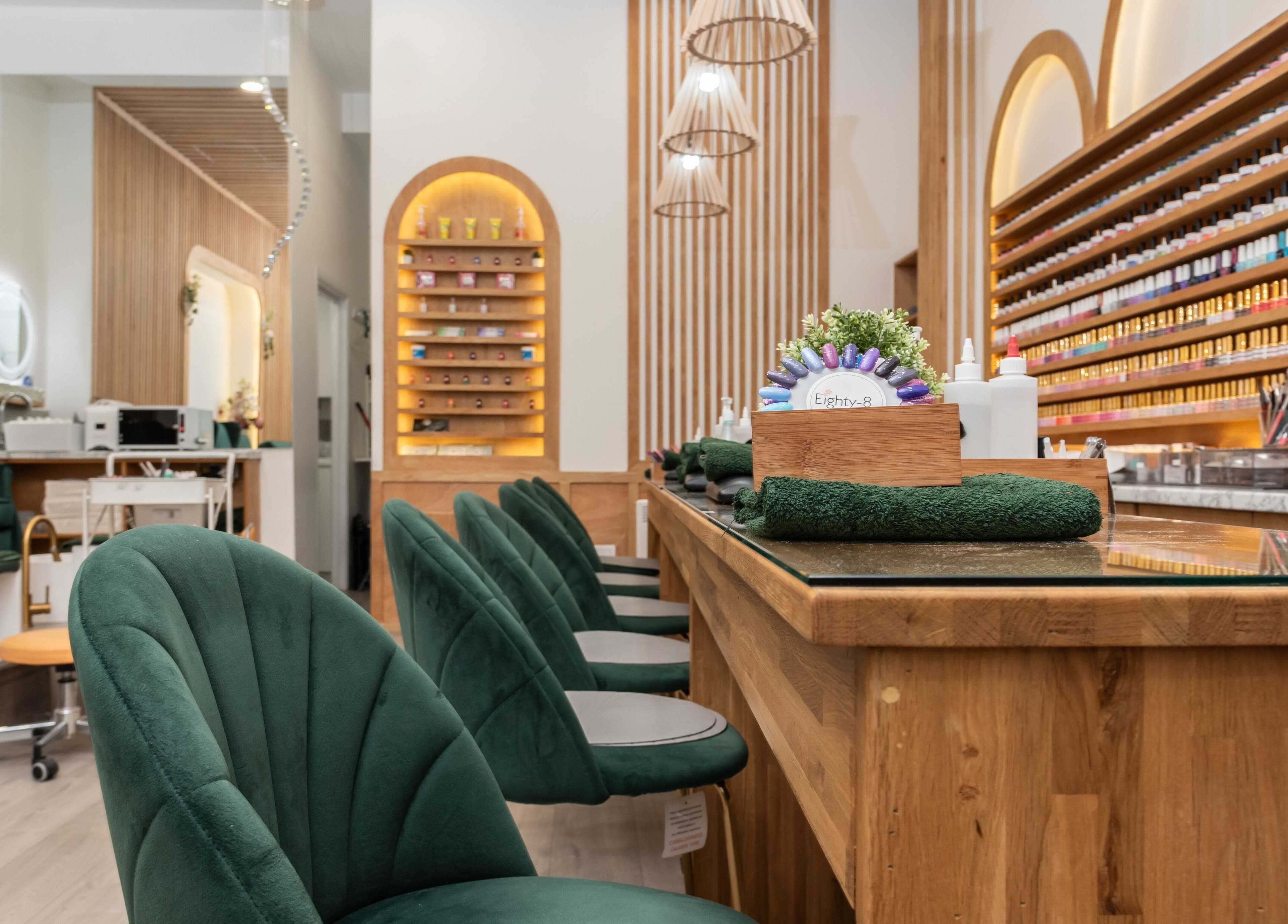 Elegant nail salon at Eighty-8 Covent Garden, London, England, GB with plush green chairs and polished decor.