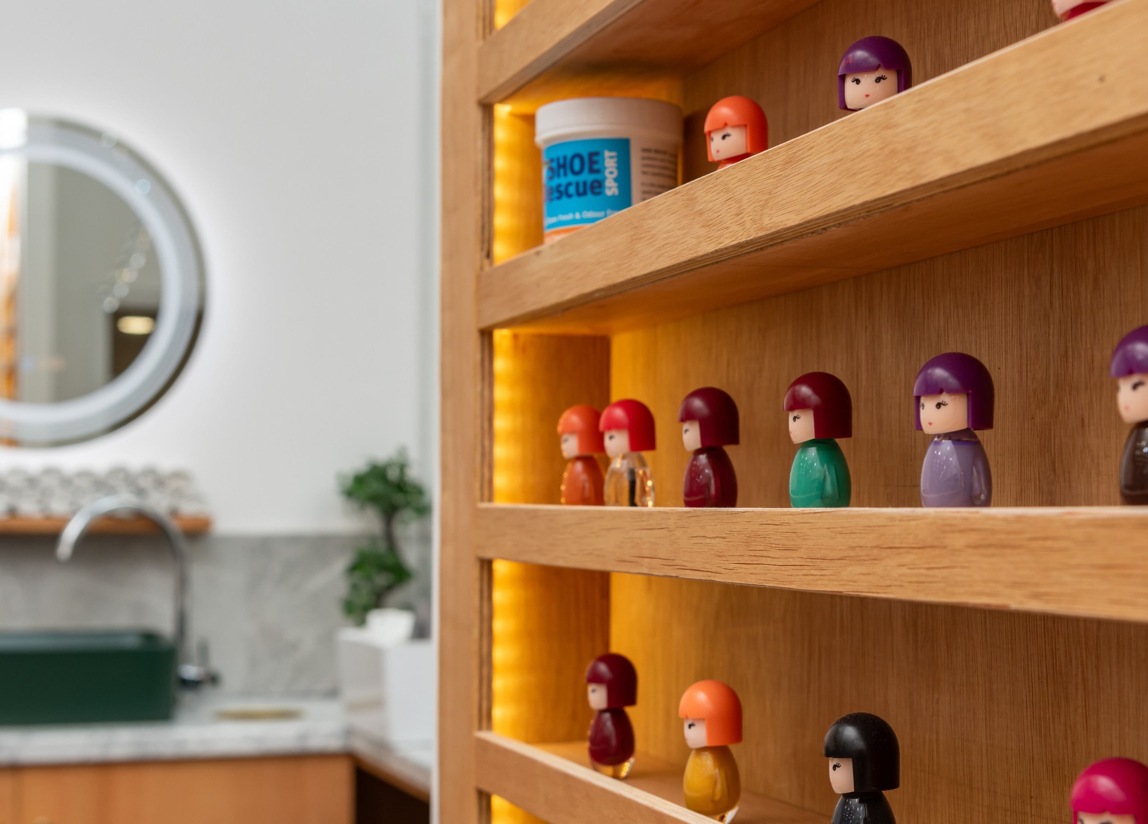 Vibrant toy figures on wooden shelves at Eighty-8 Covent Garden, London, England, GB, enhancing interior charm.