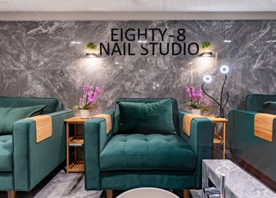 Eighty-8 Kings Road, a chic nail studio in London, England, GB, featuring plush green chairs and elegant decor.