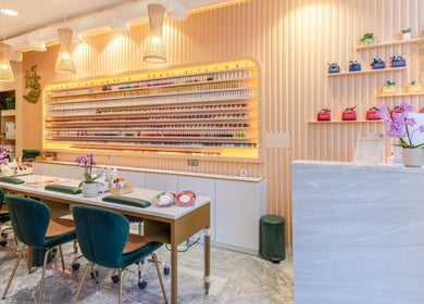 Elegant nail salon at Eighty-8 Kings Road, London, England, GB featuring modern decor and vibrant nail polish display.