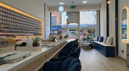 Elegant interior of The Nail Town in London, England, GB featuring plush seating and extensive nail polish selection.