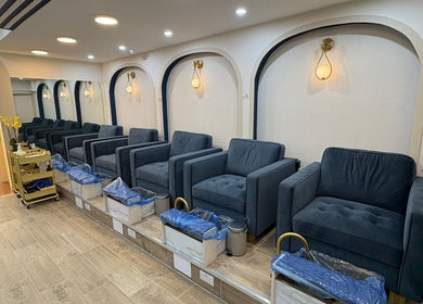 Elegant pedicure lounge at The Nail Town, London, England, GB featuring plush chairs and modern decor.