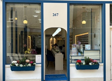 Front view of The Nail Town in London, England, GB, showcasing elegant decor and flowering window boxes.