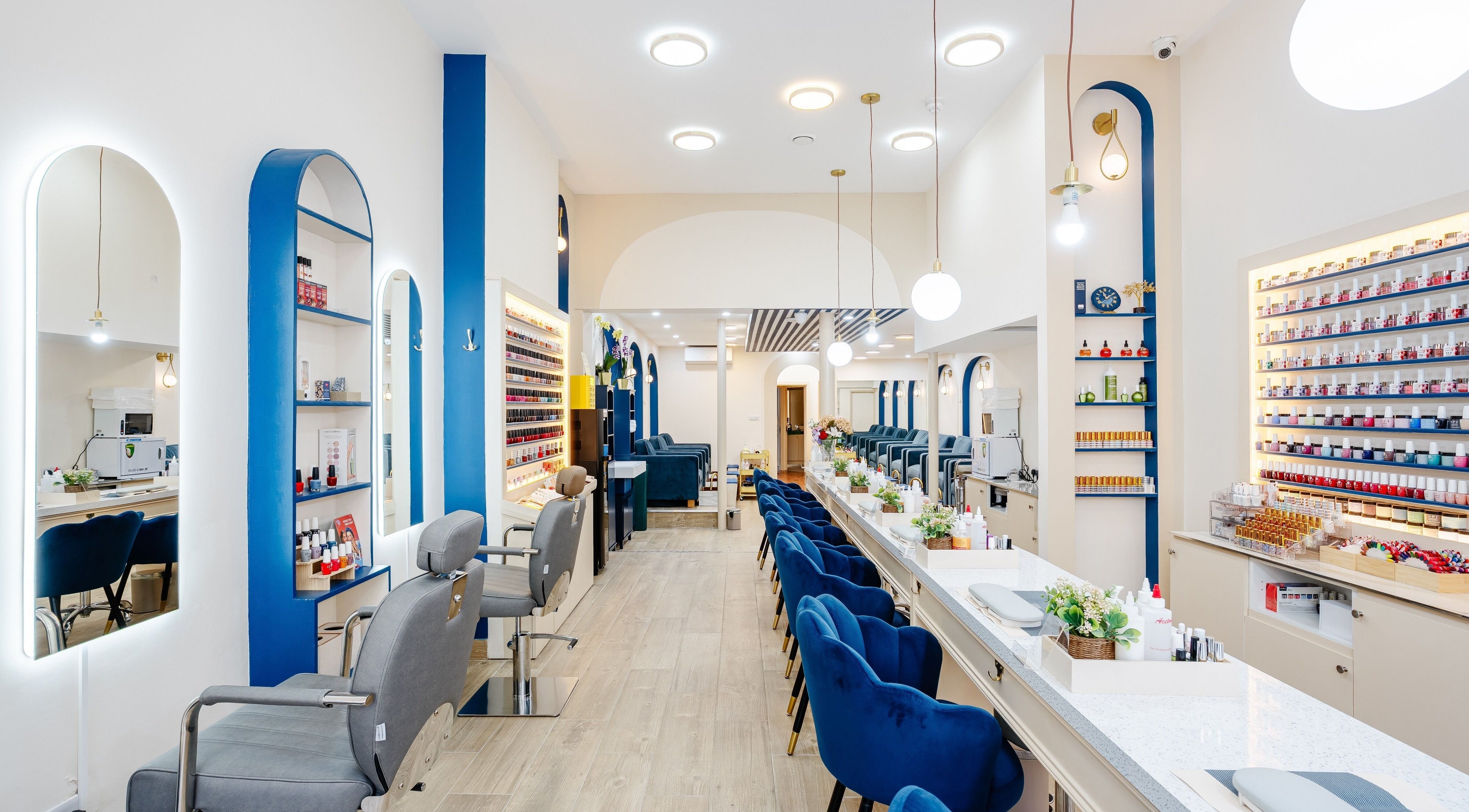 Stylish interior of The Nail Town in London, England, GB with elegant chairs and nail polish display.