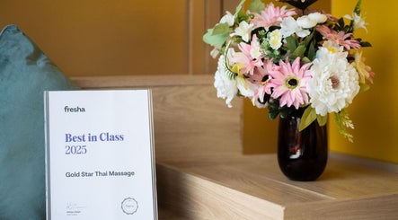 Award and floral arrangement at Gold Star Thai Massage, London, England, GB symbolizing excellence.