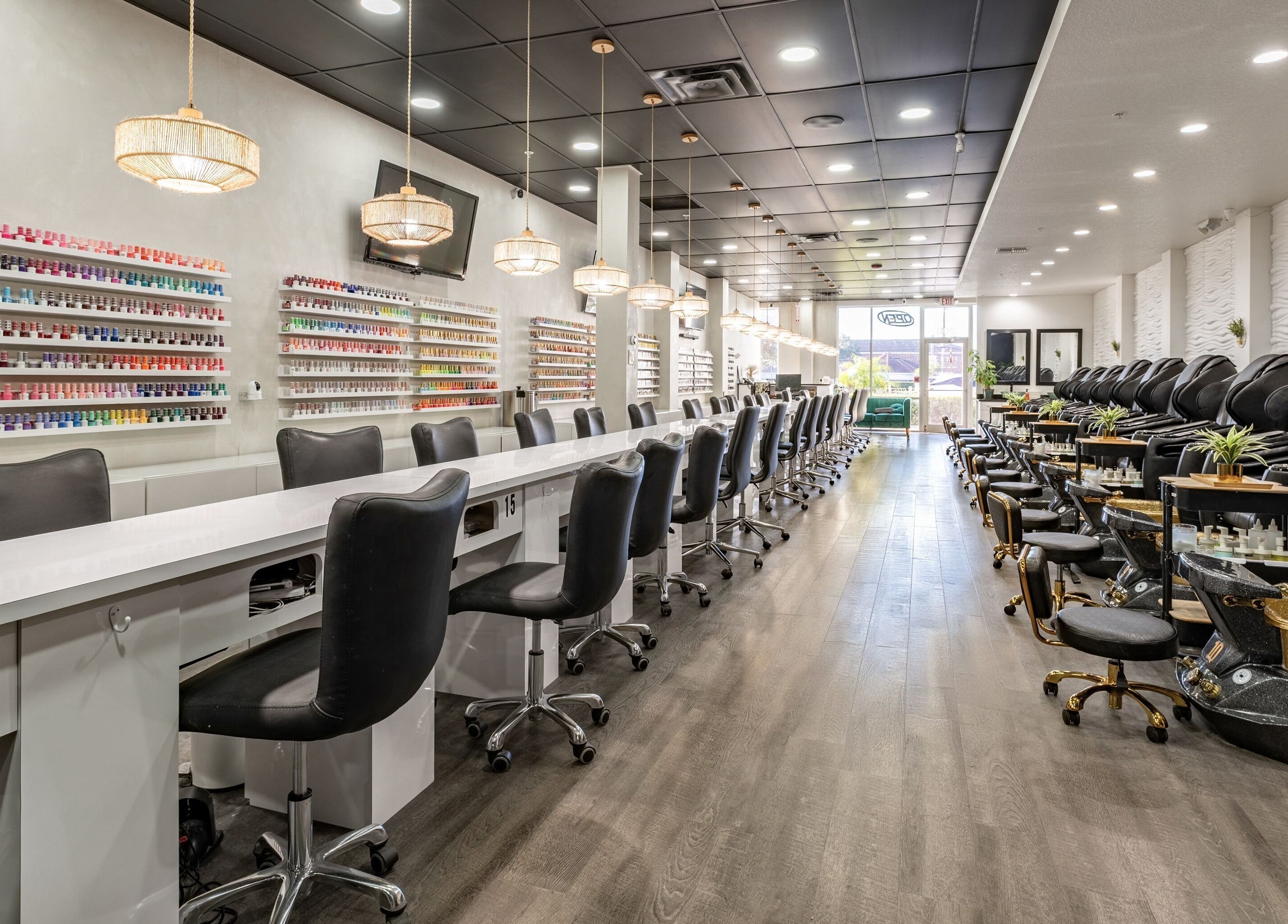 Luxurious interior of Flex-I Nails Spa in Orlando, Florida, US, featuring modern nail stations and pedicure chairs.