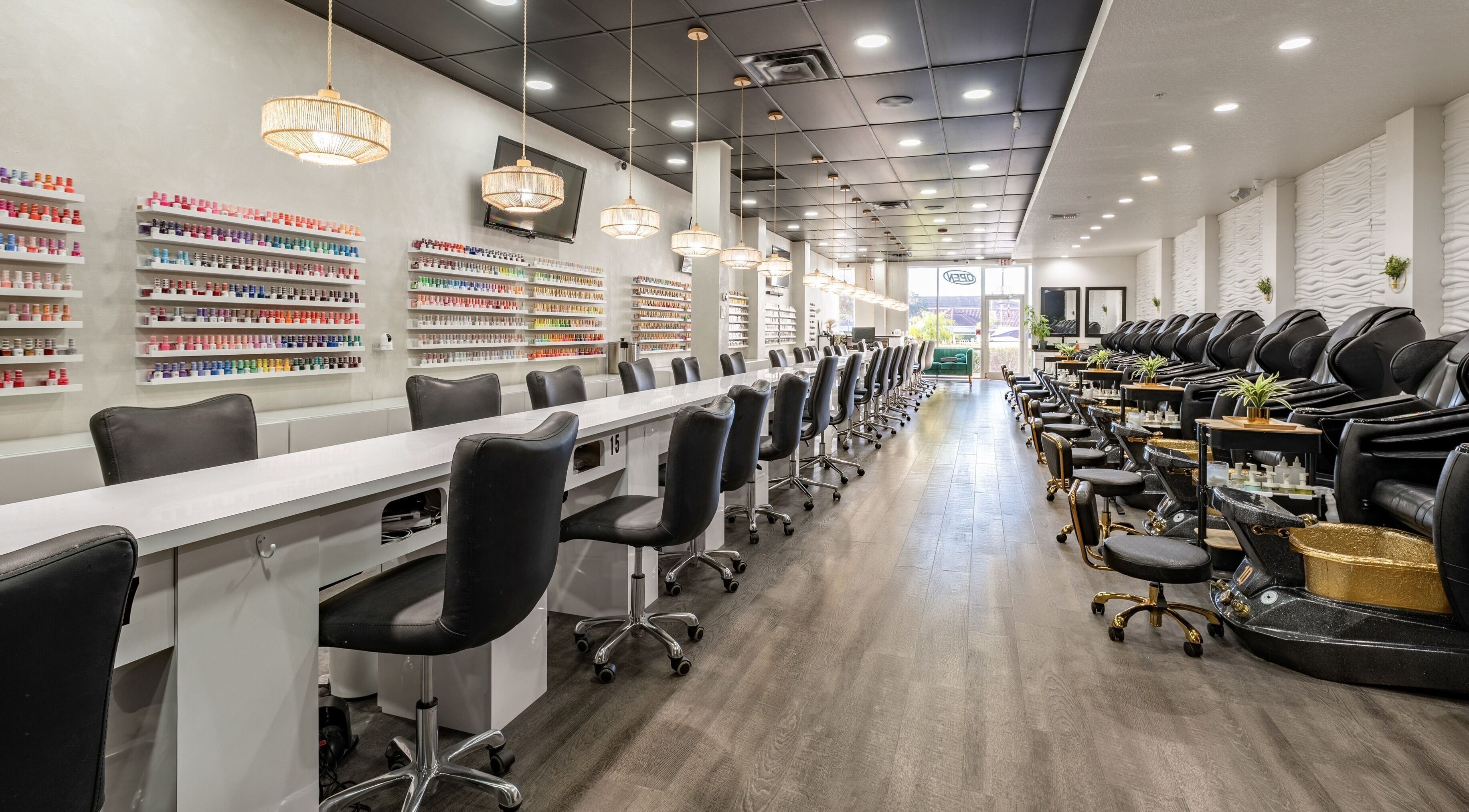Luxurious interior of Flex-I Nails Spa in Orlando, Florida, US, featuring modern nail stations and pedicure chairs.