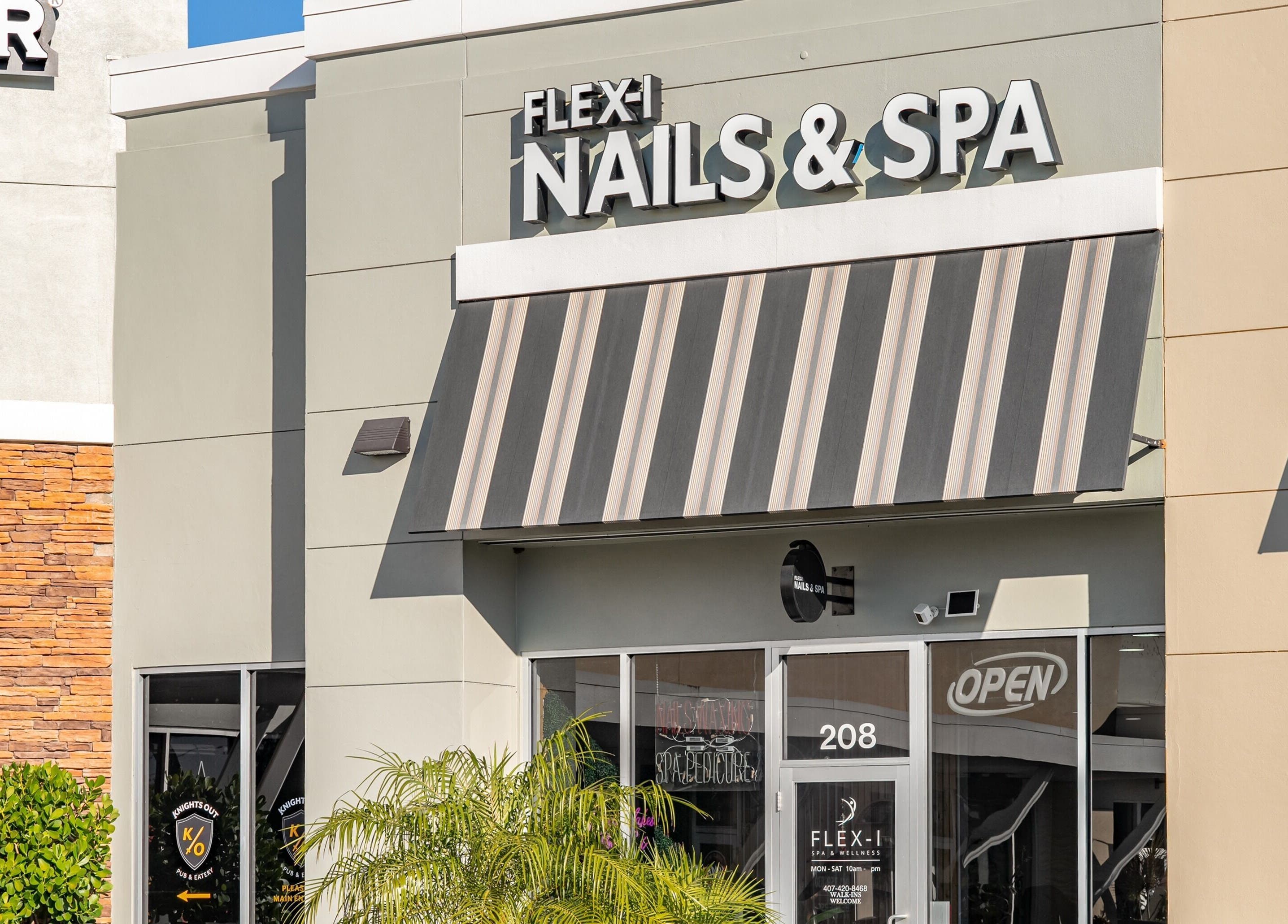 Front view of Flex-I Nails Spa located in Orlando, Florida, US, showcasing modern entrance and signage.