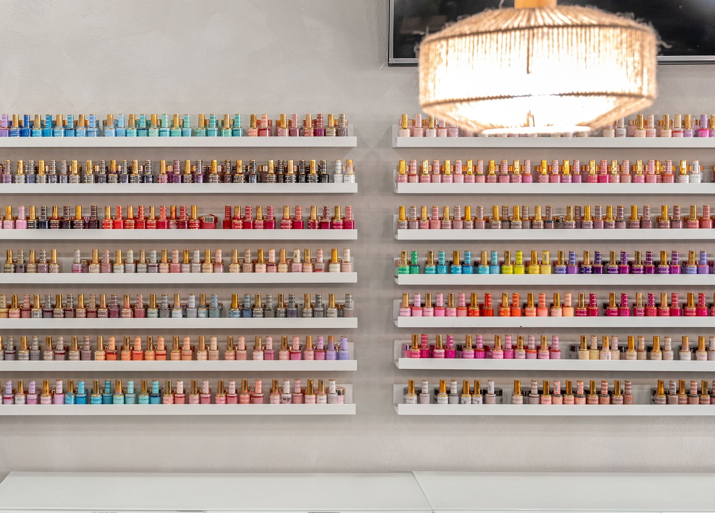 Vibrant nail polish collection at Flex-I Nails Spa in Orlando, Florida, US, showcasing a rainbow of choices.