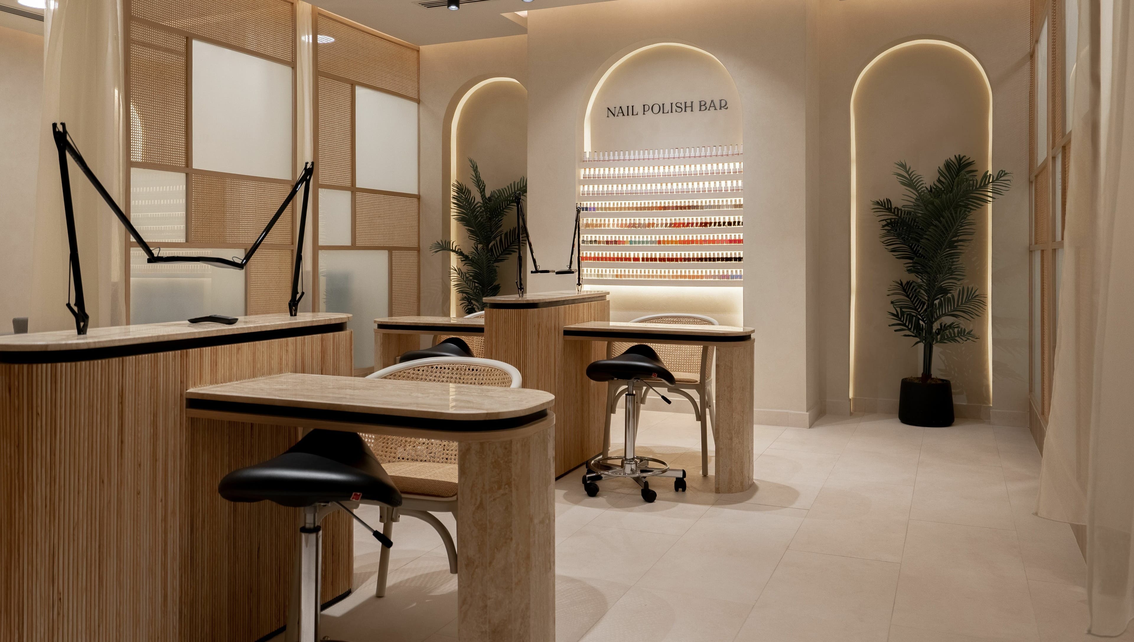 Elegant nail bar at Remedy Room, Abu Dhabi, Abu Dhabi, AE, with modern decor and nail polish display.