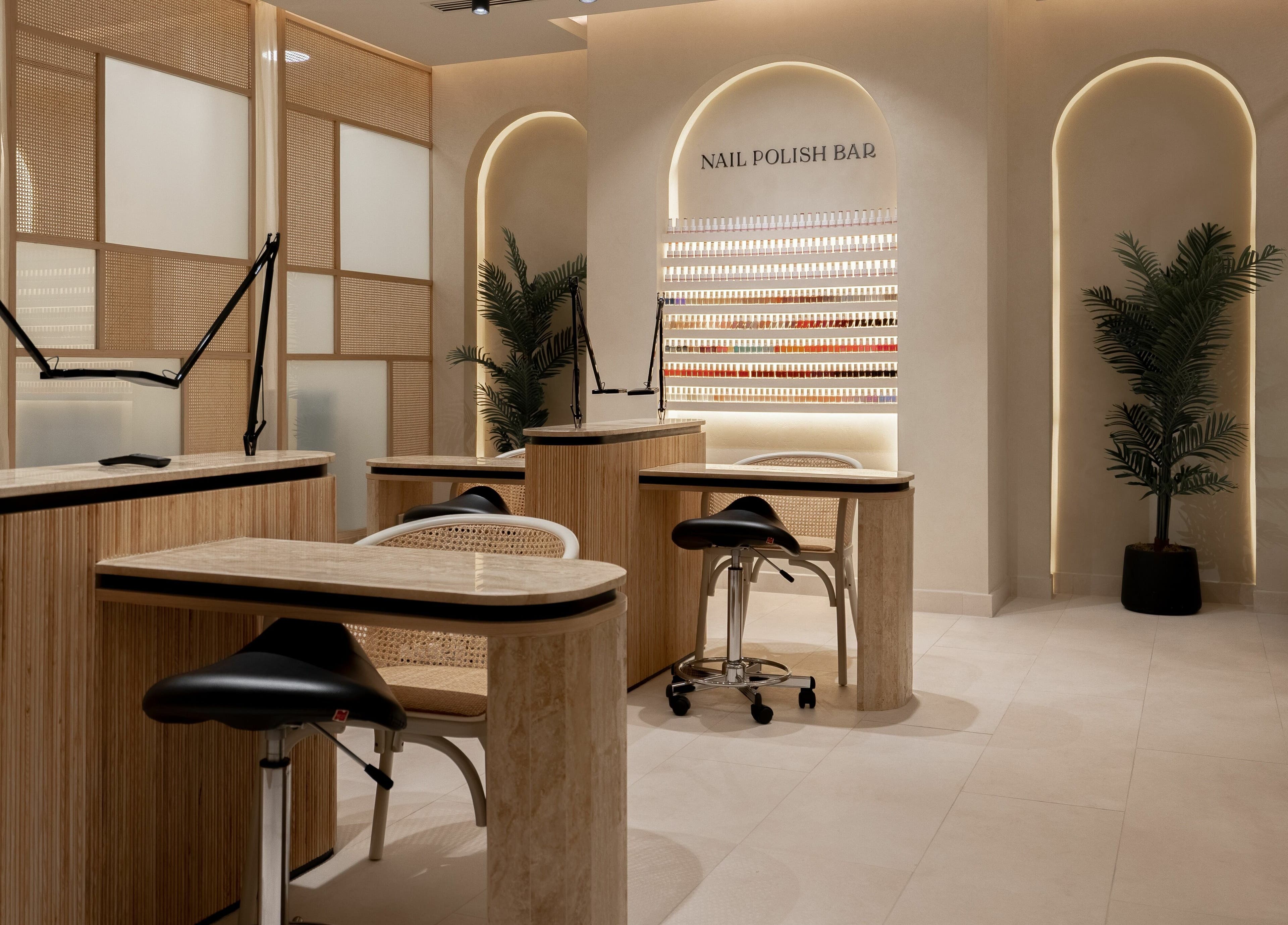 Elegant nail bar at Remedy Room, Abu Dhabi, Abu Dhabi, AE, with modern decor and nail polish display.