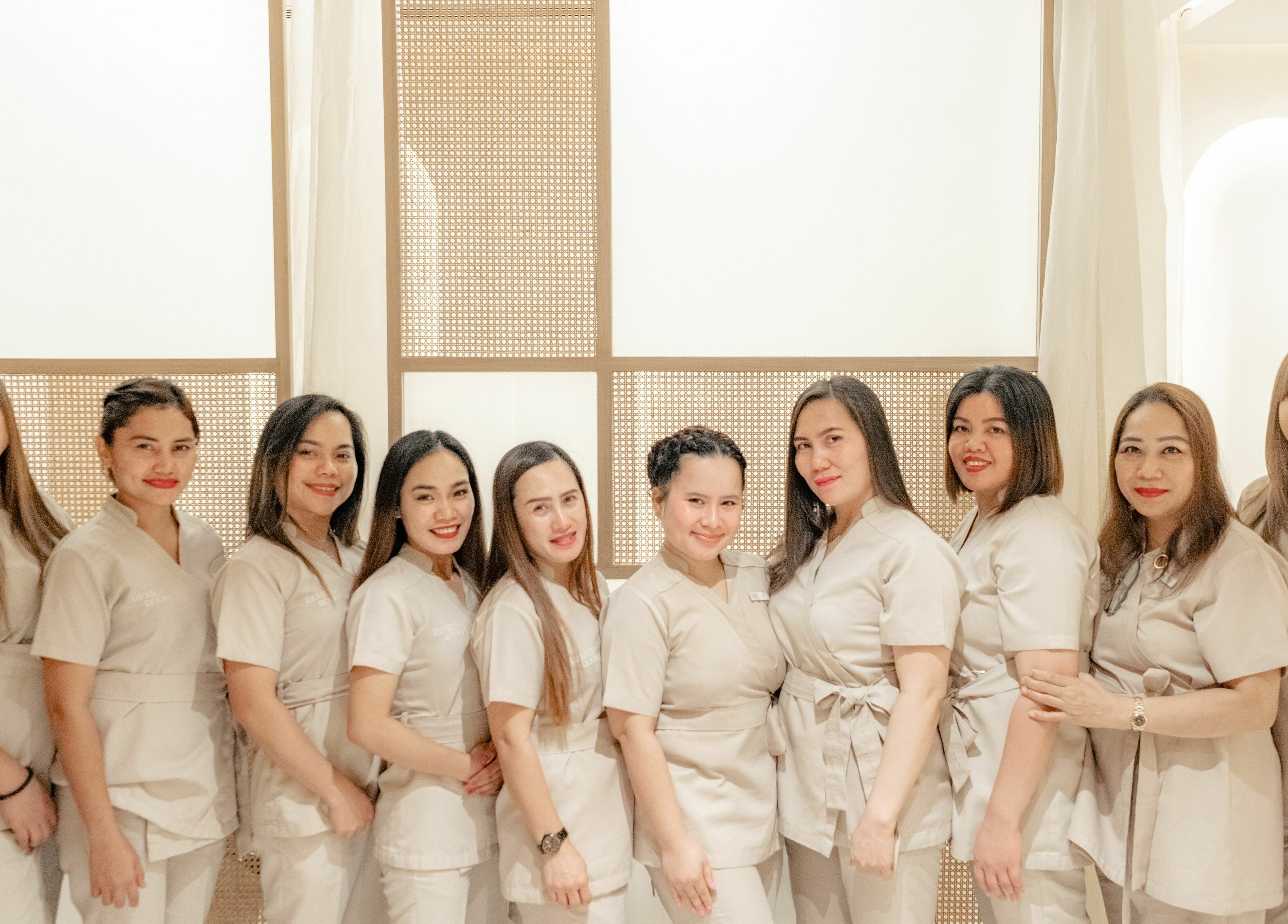 Smiling staff at Remedy Room, Abu Dhabi, Abu Dhabi, AE, ready to provide exceptional beauty and wellness services.